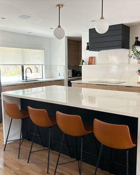 A gorgeous open concept kitchen in my friend, Katie’s home.  Love her island barstools and simple pendants.  Also the tasteful use of black here is just perfect!  Always go for a hood with some personality if you can.  Put the microwave elsewhere.  That’s my best tip for turning a builder grade kitchen into a custom look.  

#LTKHome #LTKStyleTip