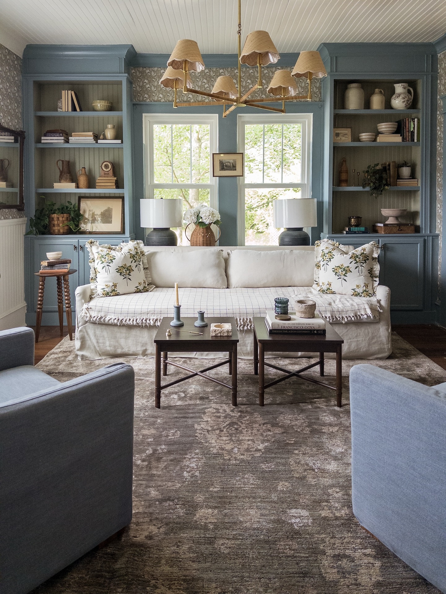 ✨You know that feeling when you walk into a room, and it just gets you? Like, the colors, the textures, the way the light hits in the afternoon… it’s not perfect, but it feels right.

That’s this room for me.

If you’re trying to get a similar vibe, here’s what worked:
	1.	Mix old + new. That vintage art, the thrifted baskets, a new lamp it all lives together like it’s been here forever.
	2.	Don’t make it matchy-matchy. The blue built-ins don’t exactly match the chairs, but that’s what makes it feel interesting and dimensional. 
	3.	Texture is everything. Pile on the pillows, the throws, the cozy vibe. A room that feels layered is a room you want to be in.
	4.	Pick a rug that does the heavy lifting. This is the Priscilla PRL-02 Olive/Sand from @loloirugs, and it’s the kind of rug that makes you think, “Was this always here?”
	5.	Let it feel a little messy. A book on the coffee table, a basket by the sofa, maybe a dog snoozing in the corner. That’s home.

#loloipriscillacollection #homevibes #cozyspaces #vintagevibes #moderncottage #collectedhome #interiorstyle #ruglove #livingroomgoals #houseandhome #apartmenttherapy #howyouhome #designsponge #homedetails #eclecticstyle #cozycorners #texturedliving #vintagestyle #myhousemystyle #layeredliving