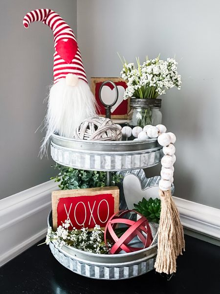 Create a fun tiered tray for Valentine’s Day. They are perfect for so many places in your home. Pops of red with cute gnome and wood signs mixed with small plants and greenery create a pretty galvanized tiered tray design. #valentinesdaydecor #tieredtraystyling #gnomes



#LTKhome #LTKfamily #LTKSeasonal