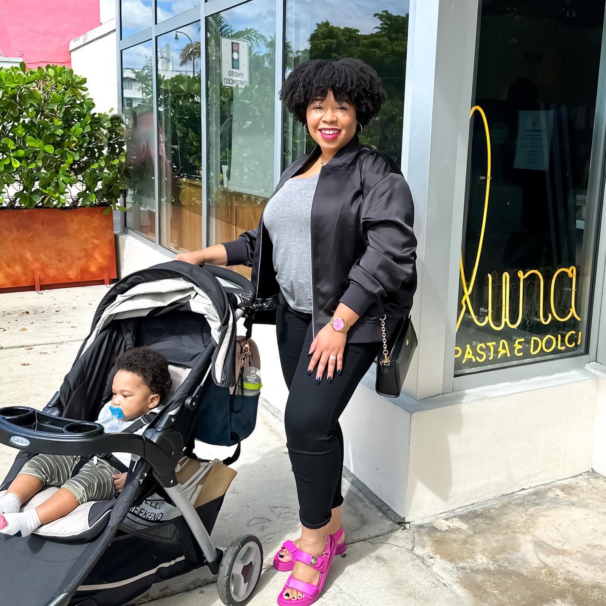 All black with a pop of color. Mom casual outfit. Black jeans with bomber jacket for curvy women. Pink Mona sandals from Steve Madden. Graco stroller.

#curvyjeans #falloutfitinspiration
#ltkcurves #ltkfamily #express 

#LTKshoecrush #LTKsalealert #LTKmidsize