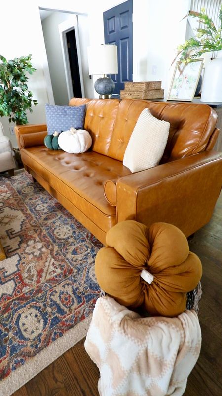 Cozy fall living room: brown leather couch, pumpkin pillows, neutral fall decor 

#LTKstyletip #LTKhome #LTKSeasonal