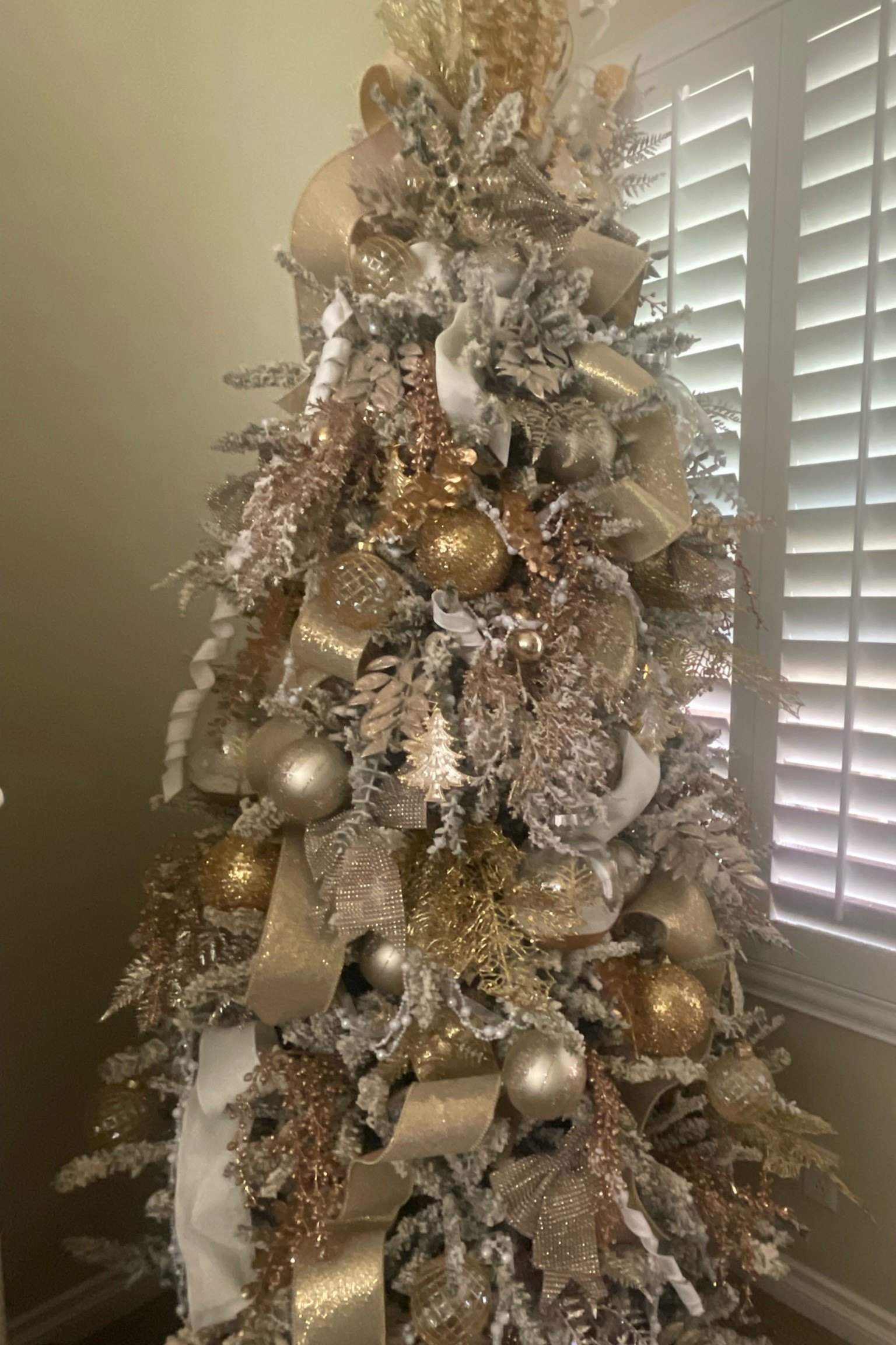 This elegant flocked Christmas tree is dripping with gold picks and ornaments, thick gold ribbon and nutcracker, church, and ball ornaments 

#LTKHoliday #LTKSeasonal #LTKhome