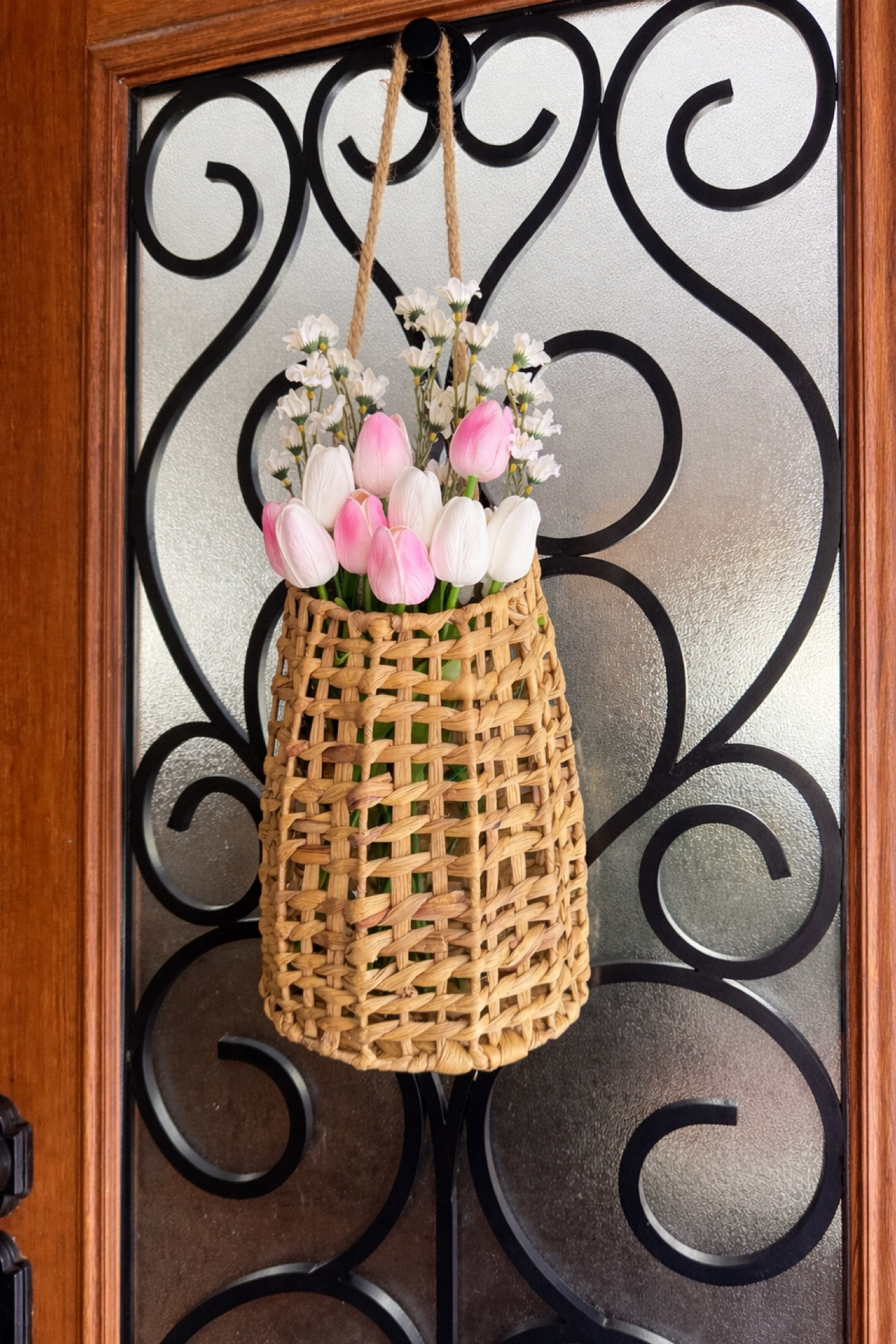 Easter front door decor 🌸 Wicker hanging basket with faux tulips for a soft spring porch look. 

#LTKHome #LTKFindsUnder50 #LTKSeasonal