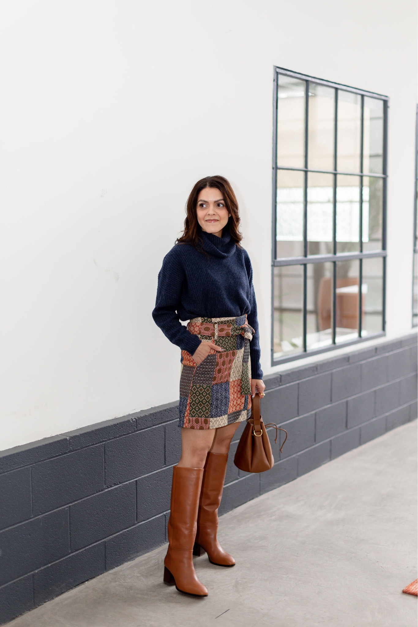 Winter outfit idea | Sezane Leandra patchwork skirt, knee high boots, turtleneck sweater, leather bucket bag 

#LTKstyletip #LTKover40 #LTKSeasonal