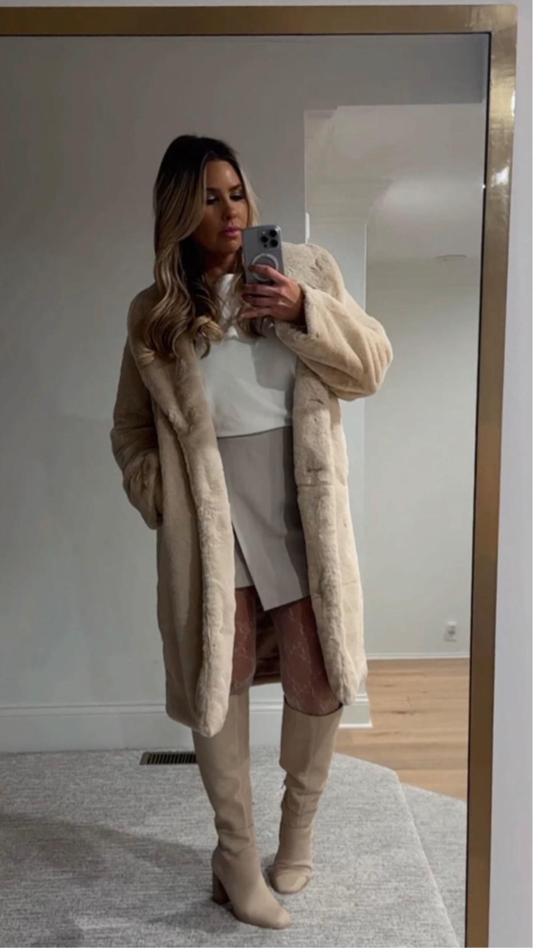 Date night outfit! Faux fur coat, skort, fishnet tights, Amazon sweater, Dolce Vita boots on sale