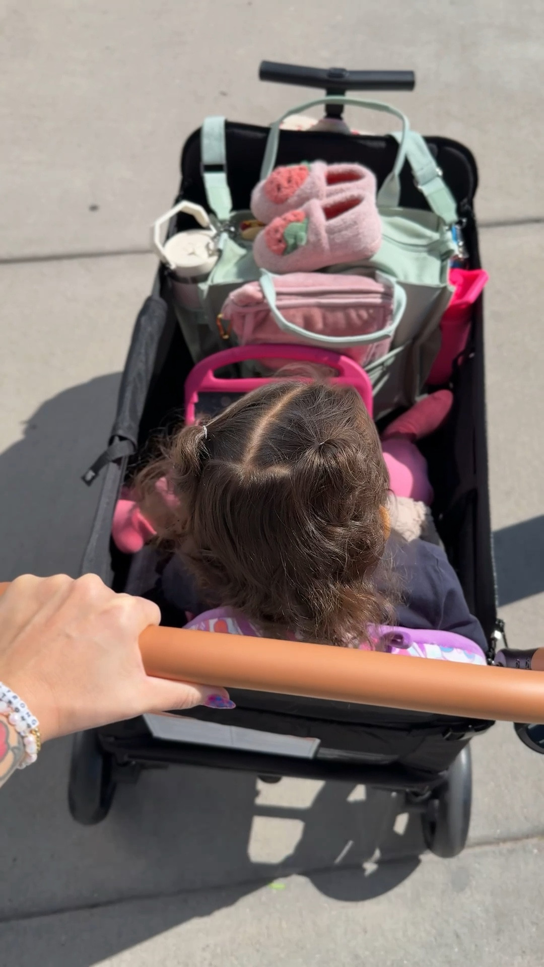 Love this wagon! 🫶🏼 has a detachable canopy/shade. I love that there is also a push (stroller like) handle and a pull handle on the opposite side. 5 point harness and a place for her to put her feet down in the wagon or keep them up.

#LTKActive #LTKFamily #LTKKids