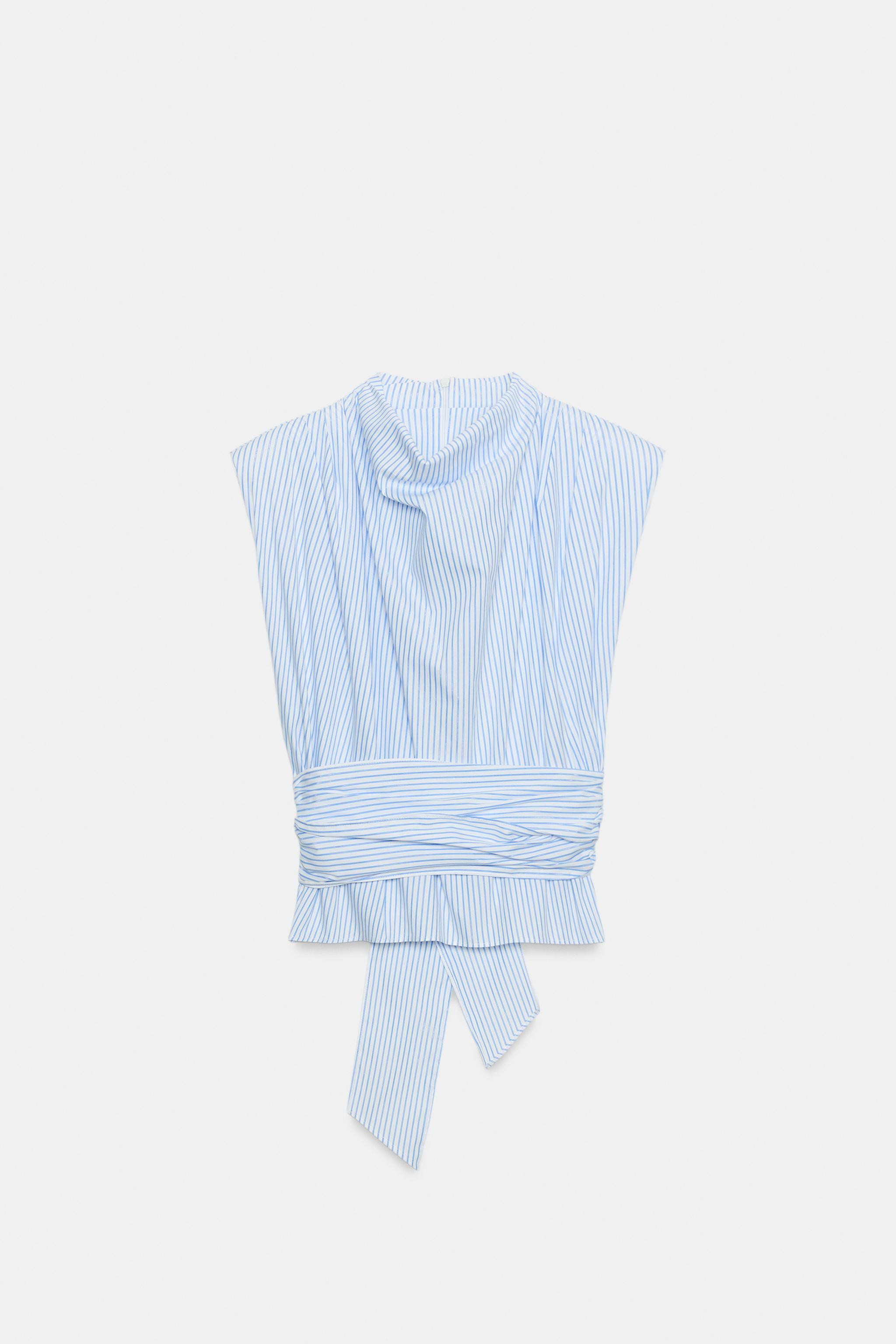 Poplin top with fluid neck and sleeveless design with shoulder pads and pleats. Metallic thread f... | Zara US