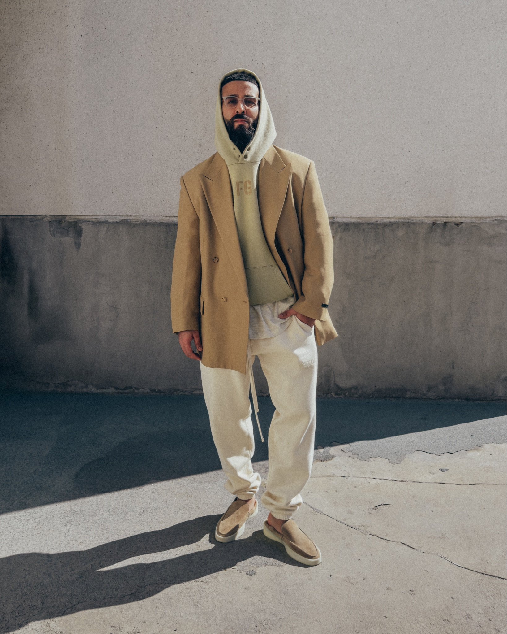 FEAR OF GOD California Blazer in ‘Camel’ (size 48), FG Hoodie in ‘Vintage Matcha’ (size M), 3/4 Sleeve Henley in ‘Cream Heather’ (size M), and The Loafer in ‘Daino’ (size 42). ESSENTIALS Sweatpants in ‘Eggshell’ (size M). FEAR OF GOD x BARTON PERREIRA glasses. A relaxed and elevated men’s look for lunch or dinner out, with light and warmer tones for Spring. 

#LTKmens #LTKstyletip