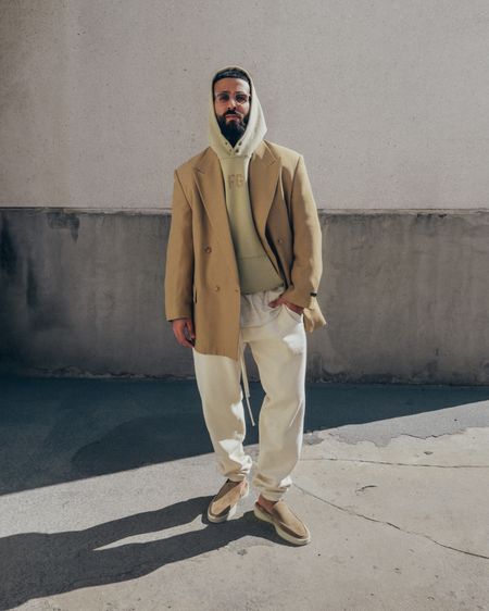 FEAR OF GOD California Blazer in ‘Camel’ (size 48), FG Hoodie in ‘Vintage Matcha’ (size M), 3/4 Sleeve Henley in ‘Cream Heather’ (size M), and The Loafer in ‘Daino’ (size 42). ESSENTIALS Sweatpants in ‘Eggshell’ (size M). FEAR OF GOD x BARTON PERREIRA glasses. A relaxed and elevated men’s look for lunch or dinner out, with light and warmer tones for Spring. 

#LTKmens #LTKstyletip