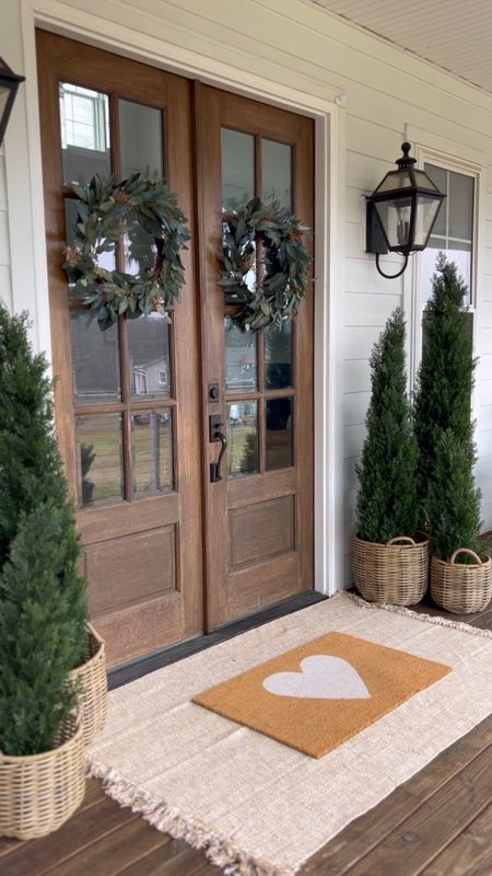 Winter Front Porch! Love these gorgeous cedar trees! I have the 3’ 5’ and 6’ and the quality is so good! They’ve been outside for almost two years! Valentine’s Day doormat heart Faux artificial and silk indoor outdoor trees plants and flowers double layered jute rug and doormat eucalyptus berry wreaths rattan resin baskets front porch and door decor home accents spring front doors evergreen trees outdoor wall sconce lantern light fixtures

#LTKhome #LTKstyletip #LTKSeasonal