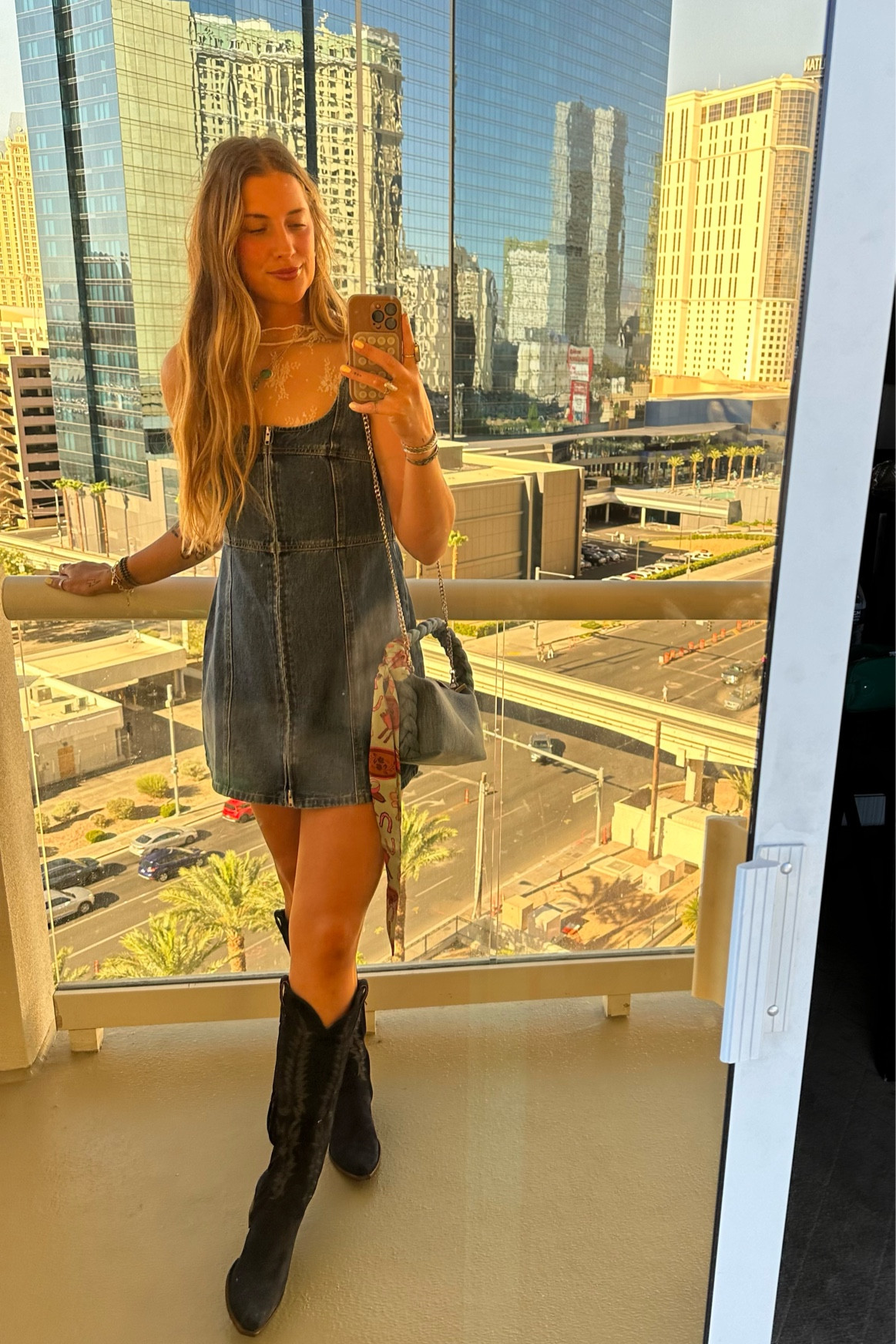 Mini denim dress 💙 wearing a large and a L in the mesh sleeveless top. Boots Old Gringos TTS. Bag Marshall’s. Bag tie from Lady the brand 🍒