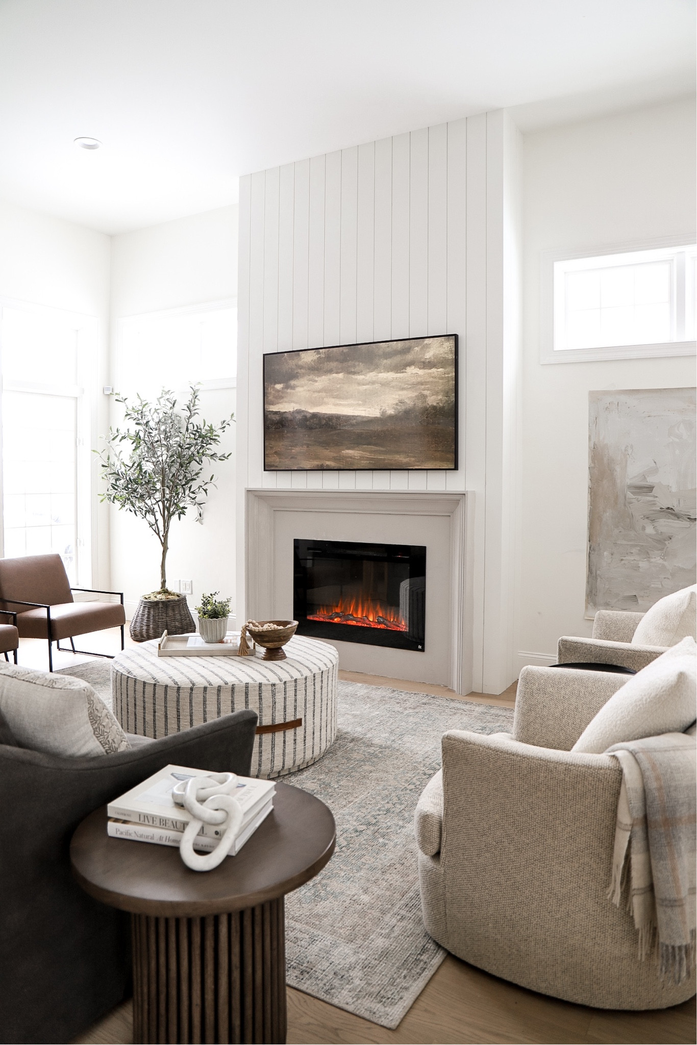 Shop my living room! 
Frame tv, artwork, pillows, sofa, swivel chair, olive tree, amazon, leather chair, area rug, loloi, fireplace, McGee & co, ottoman, home decor

#LTKstyletip #LTKfamily #LTKhome