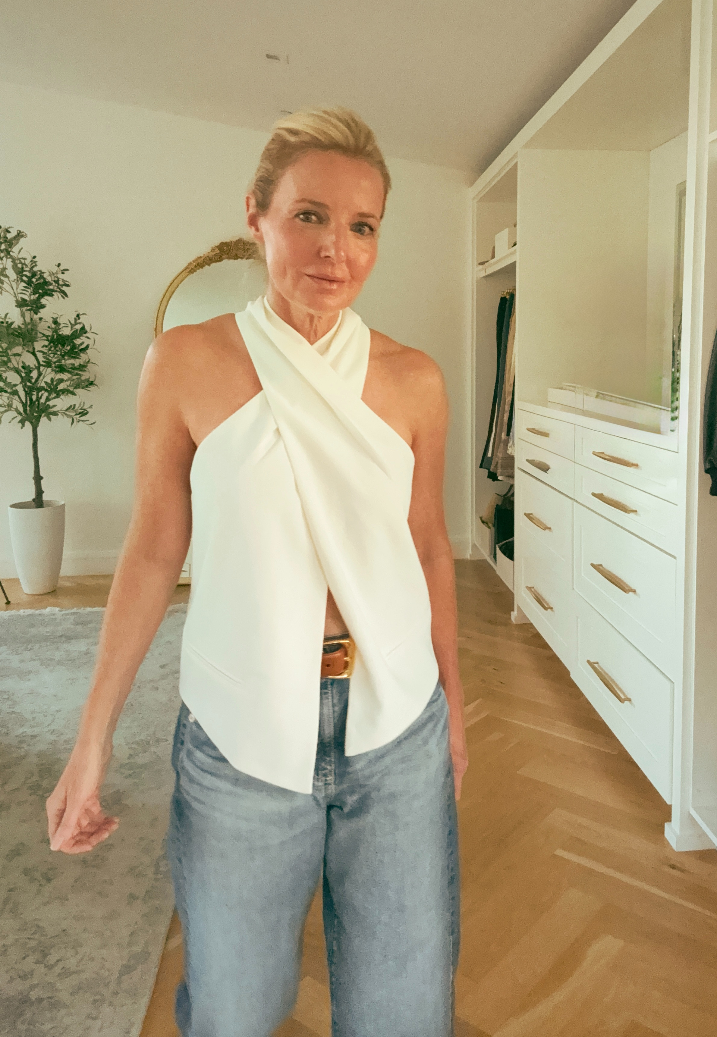 A criss cross halter top is one of the most flattering necklines there is; it draws the eye to the center, elongates the neck, and creates a beautiful shoulder line. 

This Ramy Brook ivory version is sleek and structured, not flimsy. Styled here with straight leg jeans and a tan leather belt for a polished casual look that works for so many occasions!

#LTKgrwm #LTKootd #LTKOver40