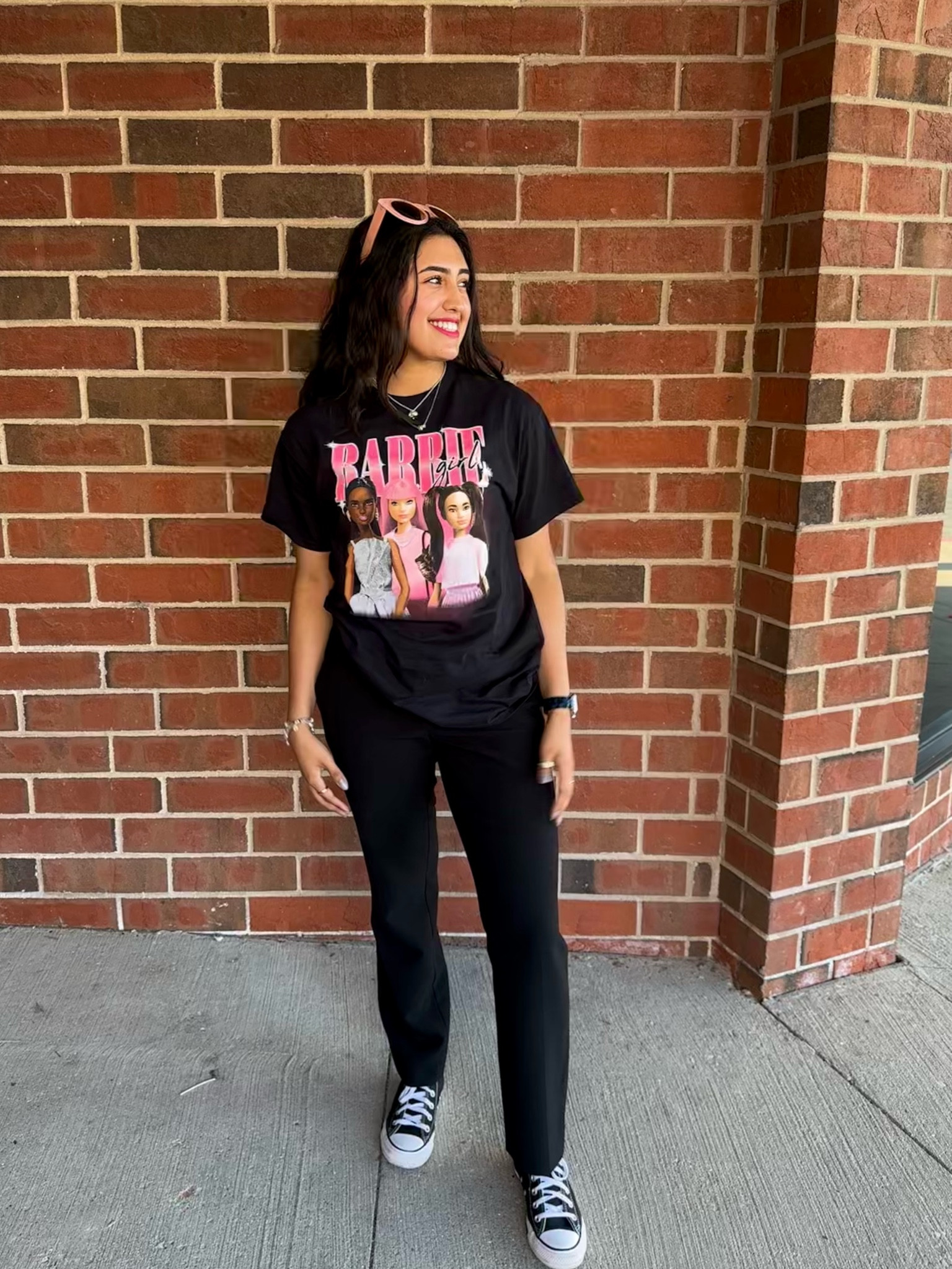 Barbie outfit black oversized t-shirt with black slacks perfect for an Oppenheimer wardrobe change. Round Pink sunglasses. Rose gold jewelry rings and fresh water pearl bracelet. Original traditional converse black and white. Not too girly for the Barbie Movie Premiere.

#LTKunder50 #LTKstyletip #LTKunder100