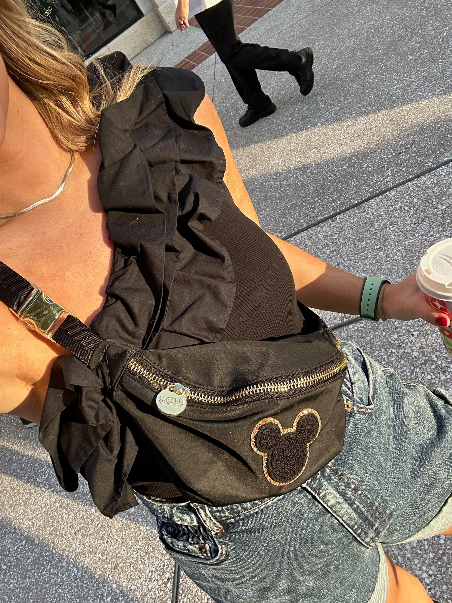 Black one shoulder ruffle top, denim shorts, Disney belt bag, resort look, Disney World vacation outfit inspiration 

#LTKtravel #LTKfamily #LTKSeasonal