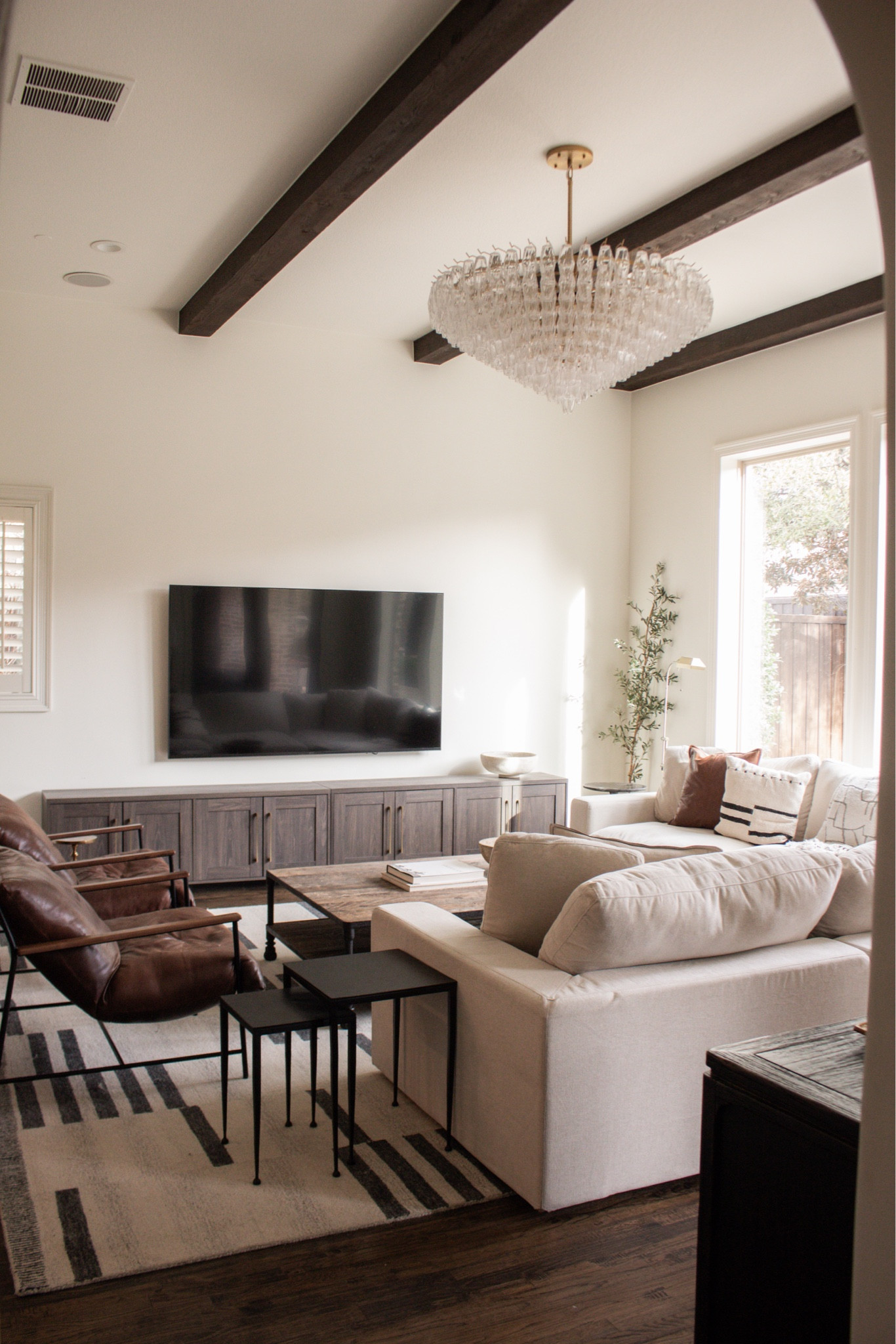 Such a beautiful example of layering neutrals. The mix of wood, leather, soft textiles, and artwork makes this living room feel warm, inviting, and effortlessly styled.

neutral living room decor, leather chair living room, gallery wall decor, cozy neutral home, warm modern living room, layered textures home, timeless home design, neutral interior inspiration

#LTKHome #LTKSeasonal