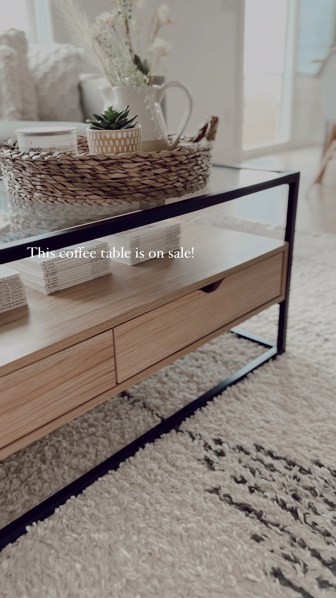 Coffee table on sale at Target!!  Living room furniture along with cream textured throw pillows.  Wood and glass modern coffee table - tray filled with faux stems and candle.  Area rug is textured and has a modern linear design.  Modern style - home decor 

#LTKhome #LTKsalealert #LTKFind