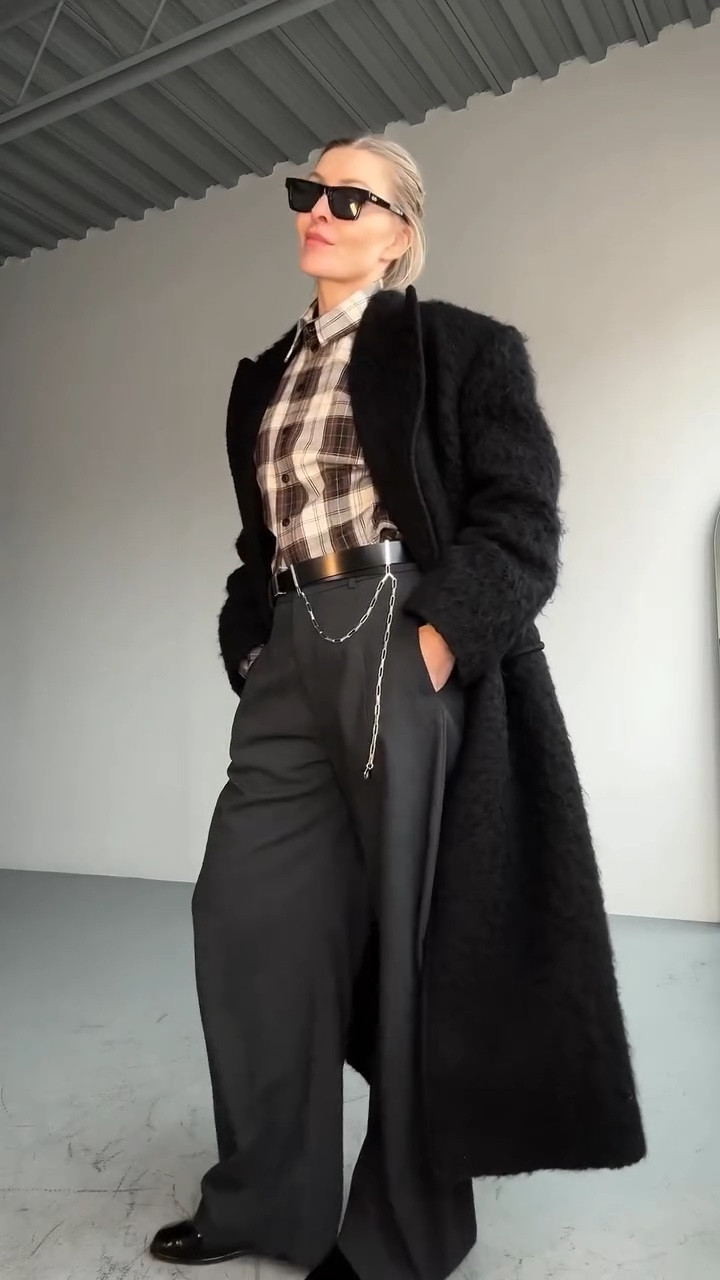 Masculine energy. Feminine control. Let’s go...

This outfit plays with structure, softness, and contrast - a masculine base (slouchy wool pants, Oxfords, a strong coat) filtered through a feminine POV.

It looks simple, but the details carry the vibe: a chain belt, brown wool socks peeking from shiny black shoes, and the fuzz of the coat softening all that tailoring.

It’s the kind of outfit that lands...if you like a bit of plaid:)

📍Style Tip: When the shapes are big or bold, balance them with quiet texture. Cozy socks. A soft shirt (plaid works, but so would a monochrome silk). Just something to break the structure... without disrupting it.

Links coming in stories.

#howtowearit #over40 #over50 #plaidshirt #plaid #theattico #bazhane #masculinestyle