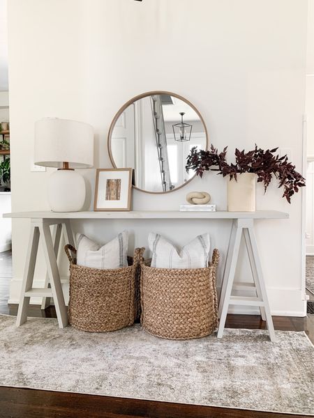 Console table styling. Entryway, faux fall stems, round mirror, neutral lamp, large woven baskets, fall art. Fall console table decor ideas! 

#LTKSeasonal #LTKhome #LTKstyletip