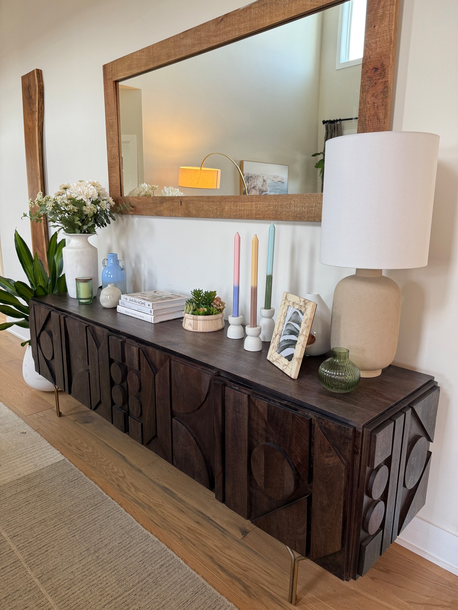 For the living room sideboard at Warrington House, we introduced subtle pops of soft color through carefully chosen candles and accessories. These delicate details add warmth and visual interest while keeping the overall look serene and cohesive.

