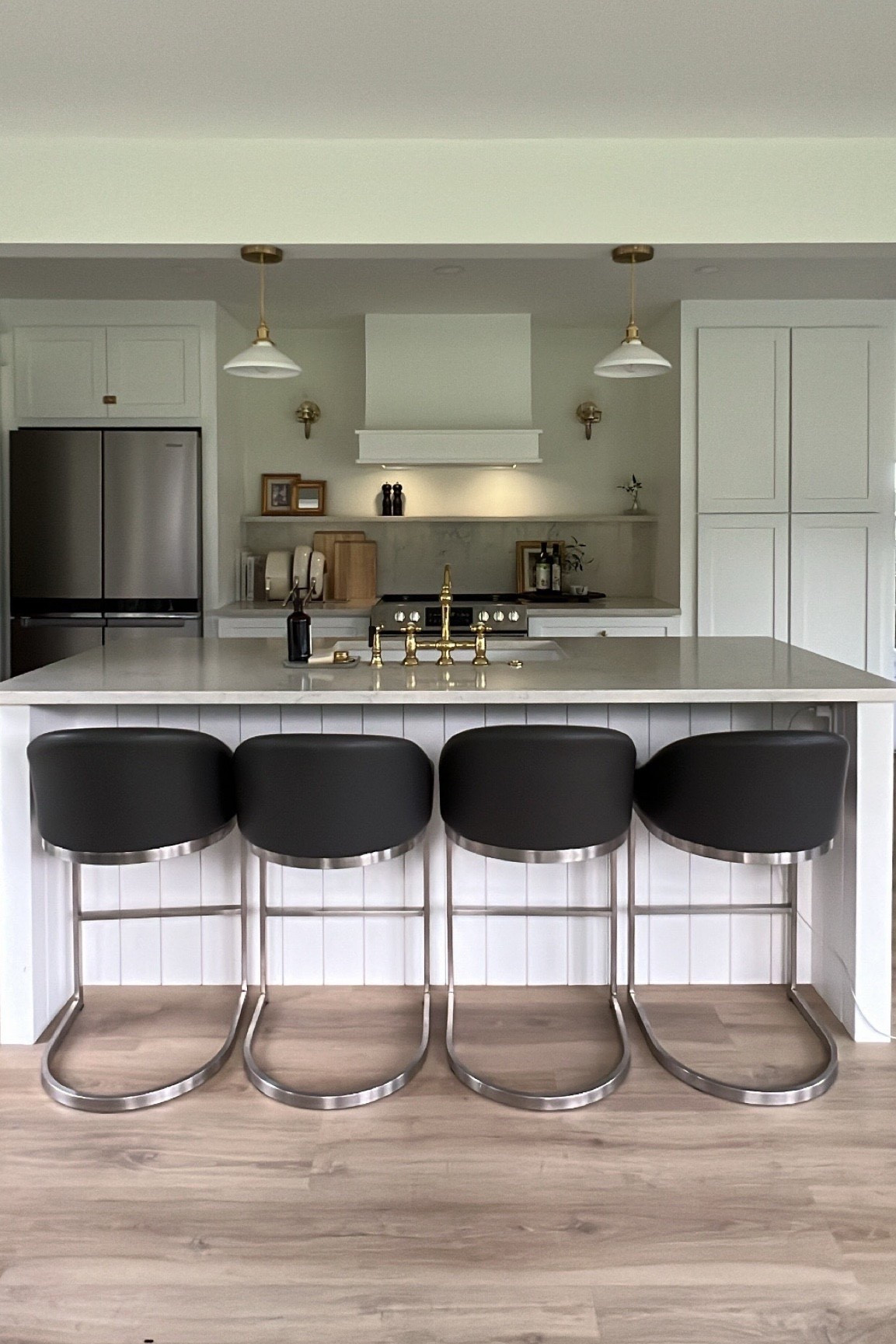 Modern farmhouse kitchen goals: 

Our kitchen island is my favorite spot in the house — perfect for coffee mornings, homework afternoons, and dinner prep with family gathered around. I went for a timeless mix of white shaker cabinets, brass fixtures, quartz countertops, and easy-to-wipe bar stools for a balance of cozy + elevated.

Details to shop:
• Counter stools – sleek, modern, and comfortable
• Pendant lighting – brass + white, classic farmhouse touch
• Bridge faucet – brass, timeless design
• Quartz island countertop – durable and family-friendly
• Modern appliances + built-in storage – clean, minimal look

This space feels both modern and warm — the heart of our home. 💛

#ModernFarmhouse #KitchenDesign #KitchenGoals #KitchenInspo #HomeDecor #InteriorDesign #WhiteKitchen #FarmhouseKitchen #CozyHome #KitchenIsland #SlowLivingHome #KitchenDetails