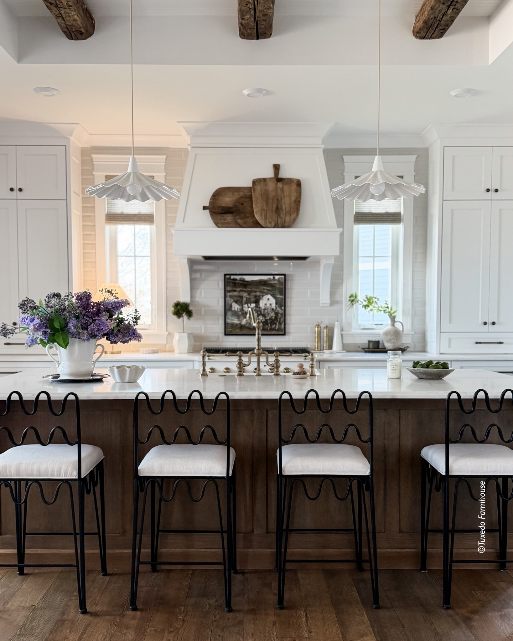 When designing my home, I wanted a kitchen that was functional, but also pretty and charming. These are a few things that were on my “want” list.

◽️A mix of white and wood
◽️Windows breaking up the cabinet wall
◽️A pretty faucet and sink
◽️Paneled appliances
◽️Extra details (corbels on range hood & island)
◽️Ogee edge on my countertops
◽️Wine fridge & entertainment area
◽️Butler pantry

~ Counter stools are from @RachelDonath.
~ Countertops are @VadaraQuartz Sterling Light. 
~ Backsplash is @JeffreyCourt Beveled Field Tile in Gloss Mt. Mist, 3x12. 
~ Floors are custom, character grade white oak — see highlights for finish details.

Everything else should be linked  

#LTKdayinmylife #LTKHome #LTKSeasonal