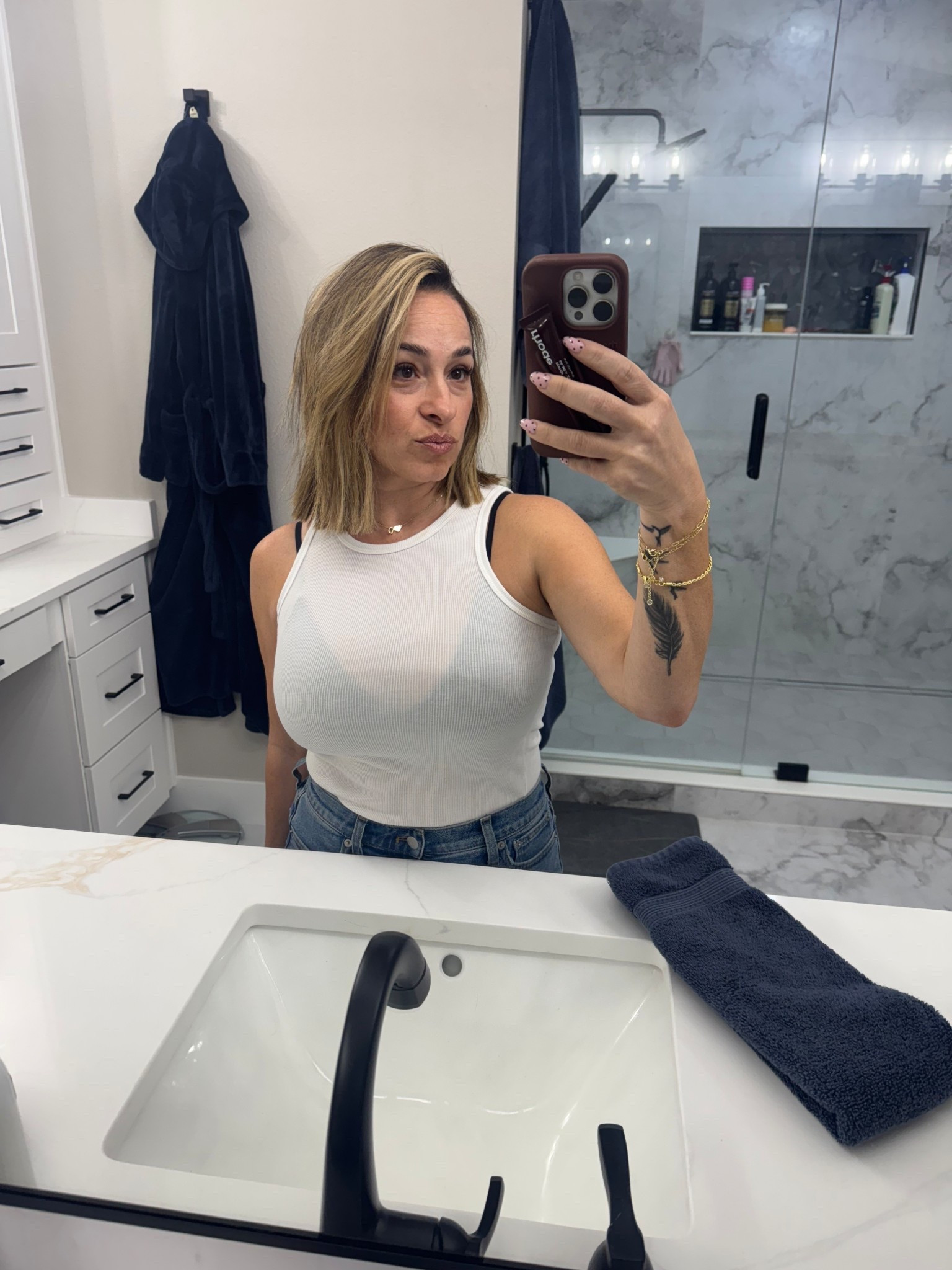White ribbed muscle tank top lightweight, stretchy, and perfect for layering with a black bralette or pairing with denim for a casual, everyday look.