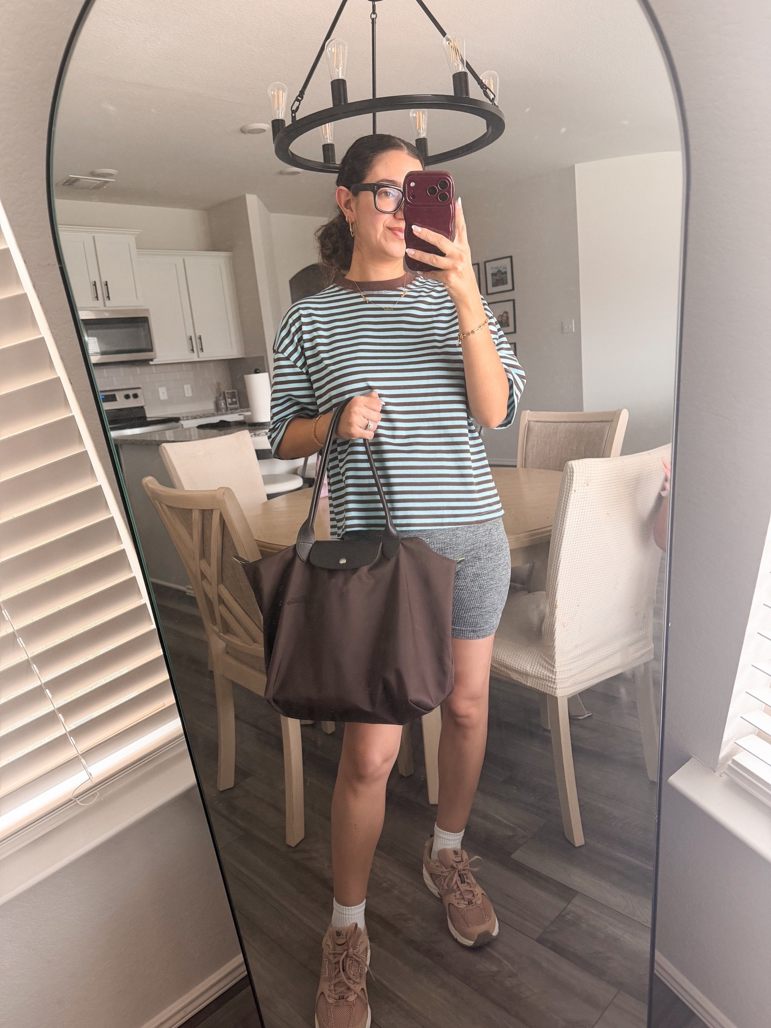 casual outfit of the day 🤎🩵 loving this oversized striped tee paired w bike shorts and my new balance’s. my long champ bag is my fave!

#LTKootd #LTKSeasonal #LTKActive