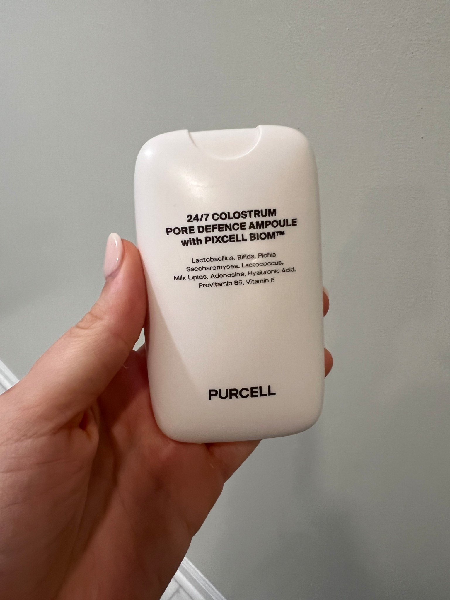Purcell 24/7 Colostrum Pore Defence Ampoule
This little white bottle feels super unique. It’s packed with probiotics (lactobacillus, bifida, saccharomyces, etc.) plus milk lipids, hyaluronic acid, and vitamin E. It’s meant to balance the skin barrier, tighten pores, and calm sensitivity. The texture is silky without being greasy, and it layers beautifully under other serums.