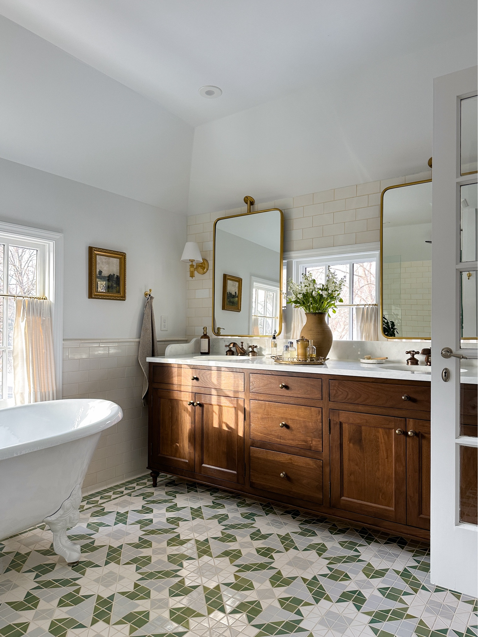 ensuite bathroom details. *brass mirrors (had them fabricated to hang from ceiling), brass sconces, landscape artwork in gold frame, handmade clay vase, vanity knobs, sink faucet, soap pump, marble tray, hand towels, brass hooks, cafe rod. Cafe curtains are custom but linking options, tiles are from Mercury Mosaics, clawfoot tub is from Signature Hardware.

#LTKhome #LTKstyletip
