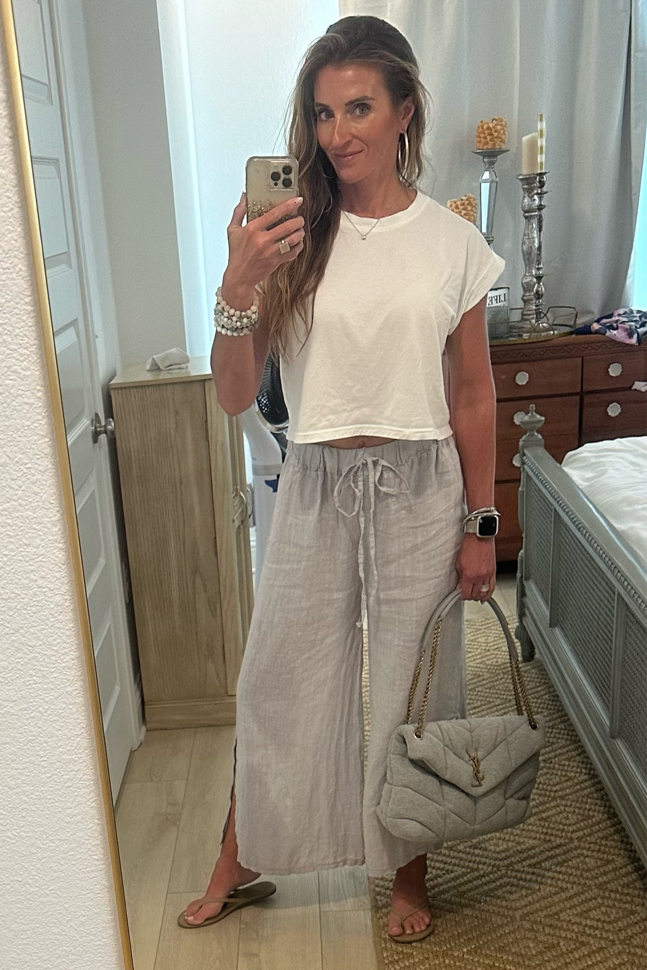 Rolled sleeve cropped shirt: https://dalesclothing.com/products/round-neck-cuffed-sleeve-top

Cropped linen pants in silver:  https://legletic.com/products/women-loose-cotton-capris-cropped-wide-leg-pants?variant=44162272624804&currency=USD&utm_medium=product_sync&utm_source=google&utm_content=sag_organic&utm_campaign=sag_organic&gad=1&gclid=EAIaIQobChMIy63a9J61gQMVNBWzAB0ZYAo2EAQYASABEgItHPD_BwE