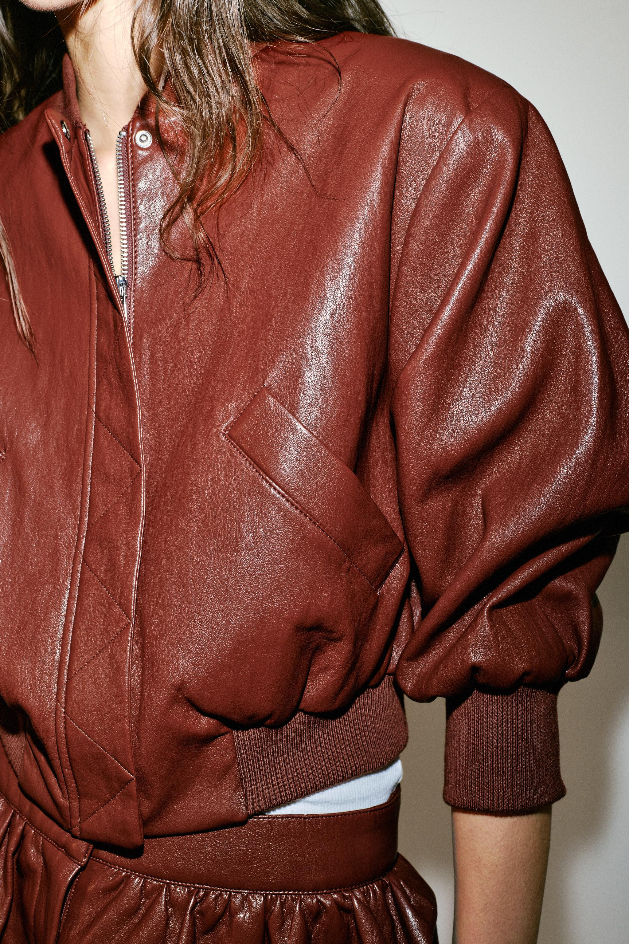 Round neck cropped bomber jacket with elbow-length sleeves and shoulder pads. Front welt pockets.... | Zara US