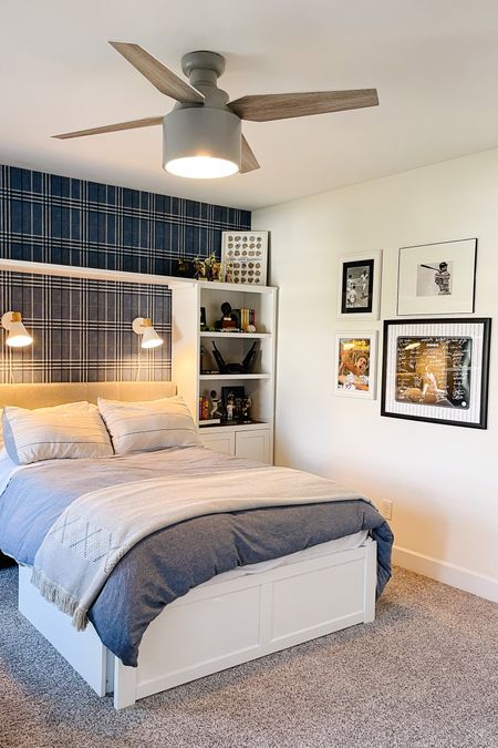 Boy’s bedroom decor idea: plaid wallpaper accent wall, playroom bed with storage, bookcase replacing nightstand, wall sconces and cHunter ceiling fan 💙

#LTKstyletip #LTKhome #LTKkids
