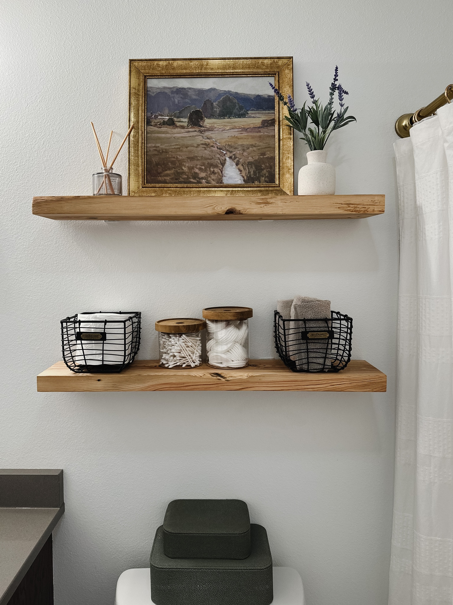 Bathroom shelfie, bathroom shelf styling, studio McGee art, decor boxes, target home finds, studio McGee home decor, target sale items, black wire baskets, glass canister with wood lid, lavender stems, faux fern, brass shower curtain rod.  

#LTKSeasonal #LTKstyletip #LTKhome