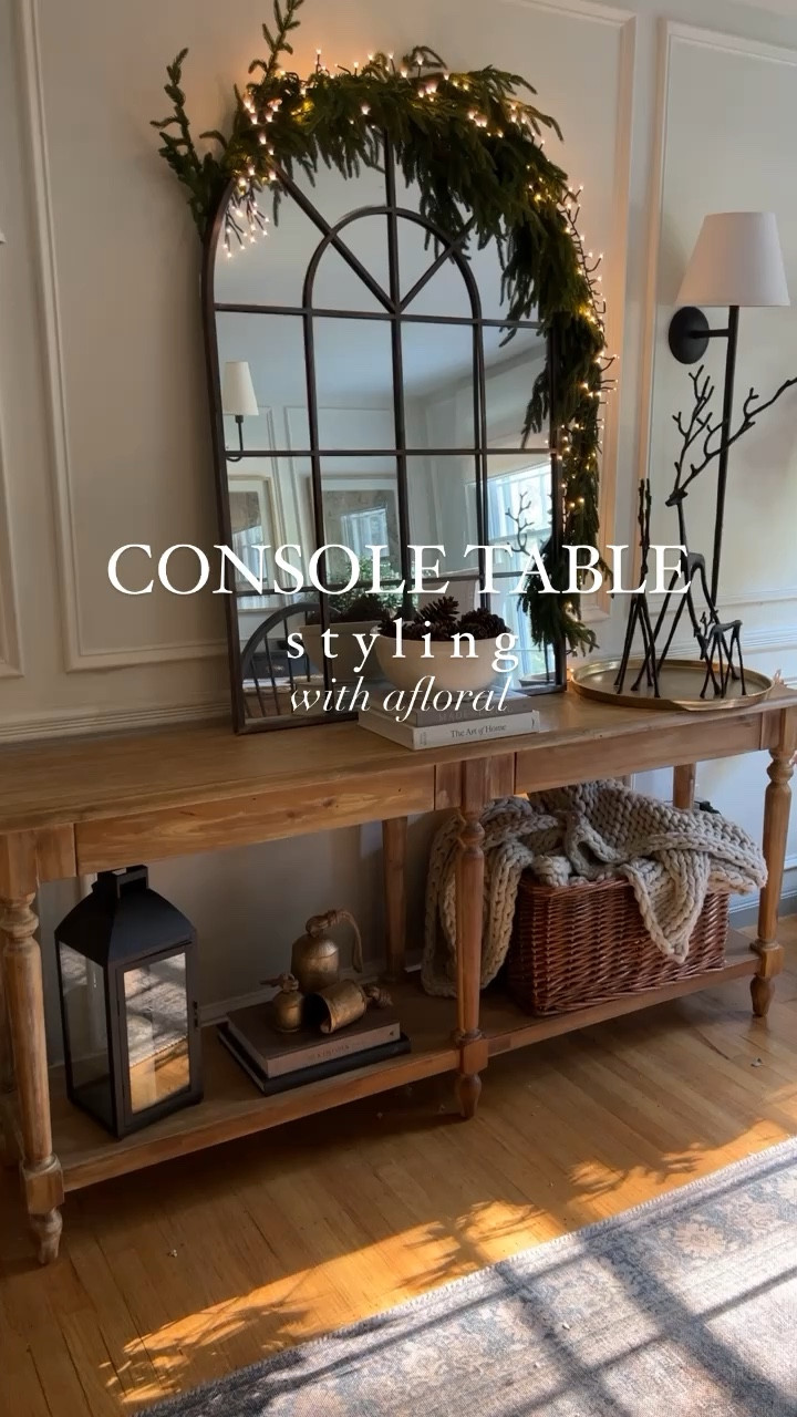 Christmas console table styling with afloral! Norfolk pine stems and garlands and pottery barn reindeeer.

#LTKHoliday #LTKSeasonal #LTKHolidaySale