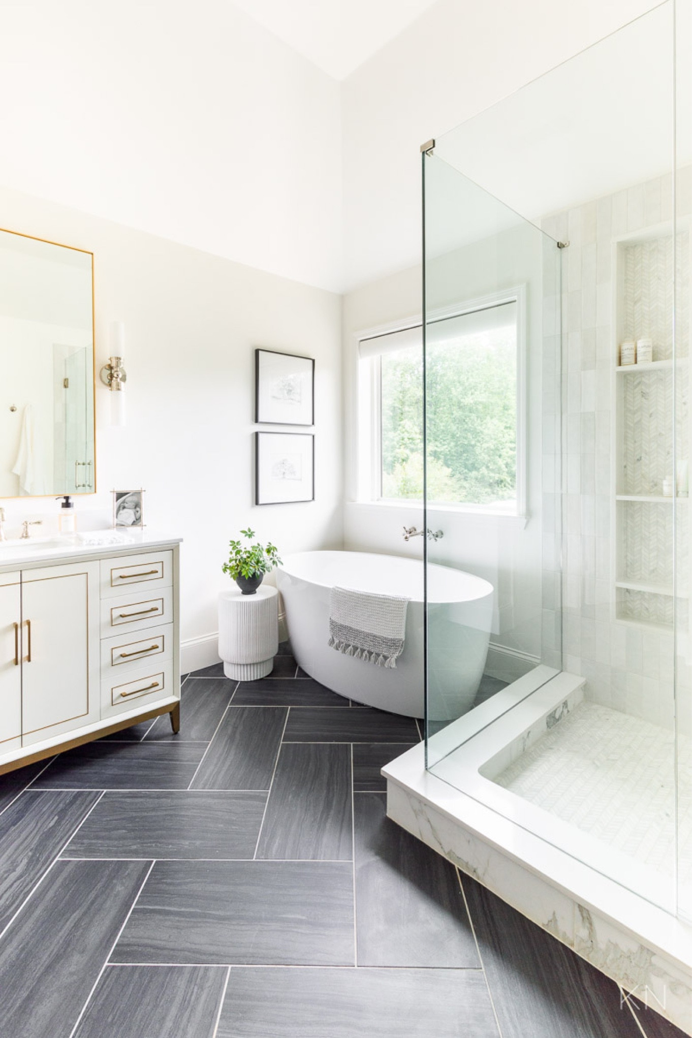 Our primary bathroom remodel was one of the biggest projects we’ve ever done. My favorite features are the three different tiles we used: black floor tile set in a herringbone pattern, vertical shower wall tile and chevron marble mosaic tile for the shower floor and shower niche. home decor bathroom decor white vanity fluted side table freestanding tub 

#LTKStyleTip 

#LTKHome