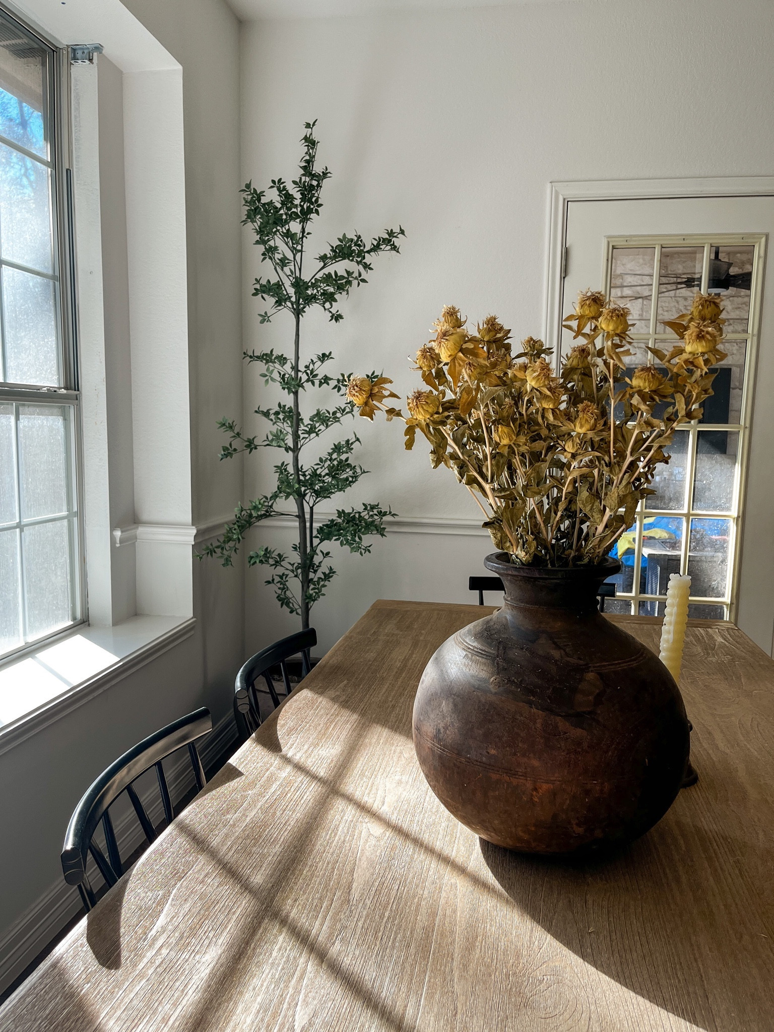 Faux black olive tree in dining room 

#LTKhome #LTKSeasonal #LTKstyletip
