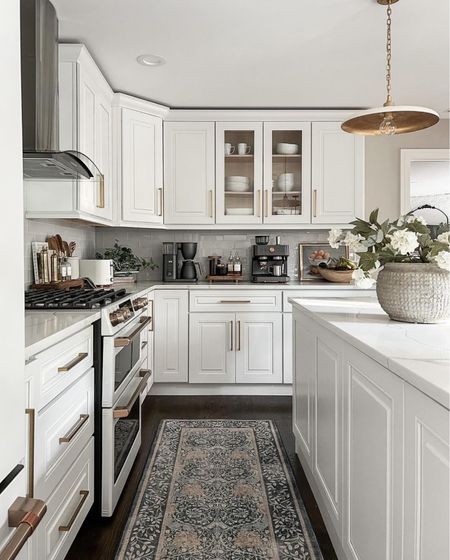 Warm white kitchen styling. I add in pops of brass, wood tones, and textured rugs to add interest and dimension to our kitchen 

#LTKhome #LTKstyletip #LTKsalealert