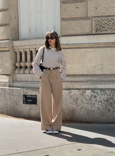 Beige trousers, pleated formal pants, striped long sleeve t-shirt, black converse, black shoulder bag, black sunglasses, sunnies 

#LTKstyletip #LTKeurope #LTKSeasonal