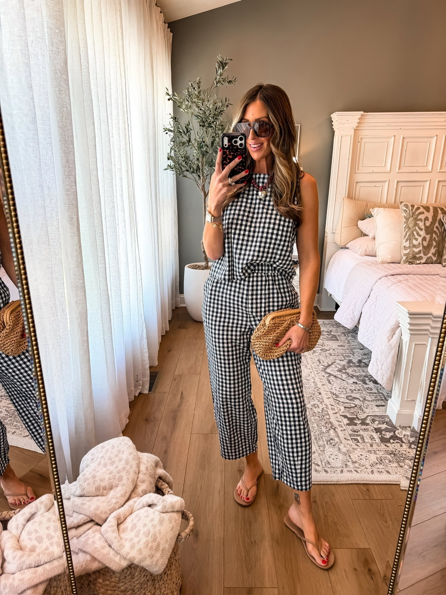 Sets outfits are my favorite in the summer 🤍 This gingham jumpsuit is lightweight, easy to throw on, and somehow still looks so put together with minimal effort. Added simple sandals and a woven clutch for an effortless everyday look you could wear to brunch, vacation, or summer events.

gingham outfit, summer jumpsuit, effortless summer style, black and white gingham, casual chic outfit, vacation outfit inspo, lightweight summer outfit, summer fashion finds, affordable summer style, easy everyday outfit, coastal summer fashion, themominstyle

#LTKmomlife #LTKSeasonal #LTKOver40