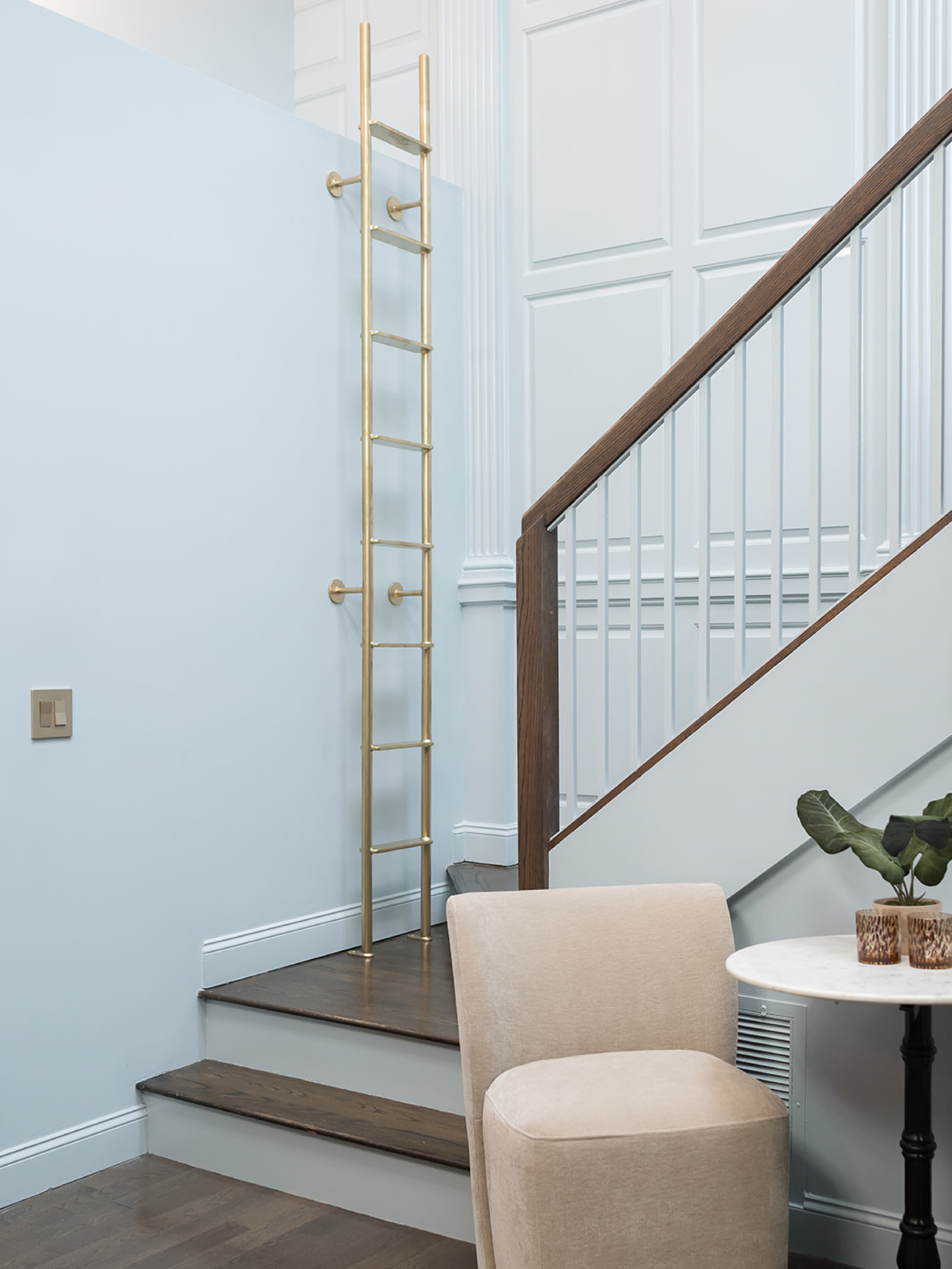 this condo features incredibly high ceilings with amazing woodwork from the building's former life as a church. in order to highlight the volume of this space and show off its full potential, #dwelloctoberstudio painted everything a dusty shade of blue and added a custom-made metal ladder that allows access to the loft space above the door. with the addition of the ladder, the loft space can be used for storage or display, and adds a fun and interesting design element. #dwelloctober

#LTKHome
