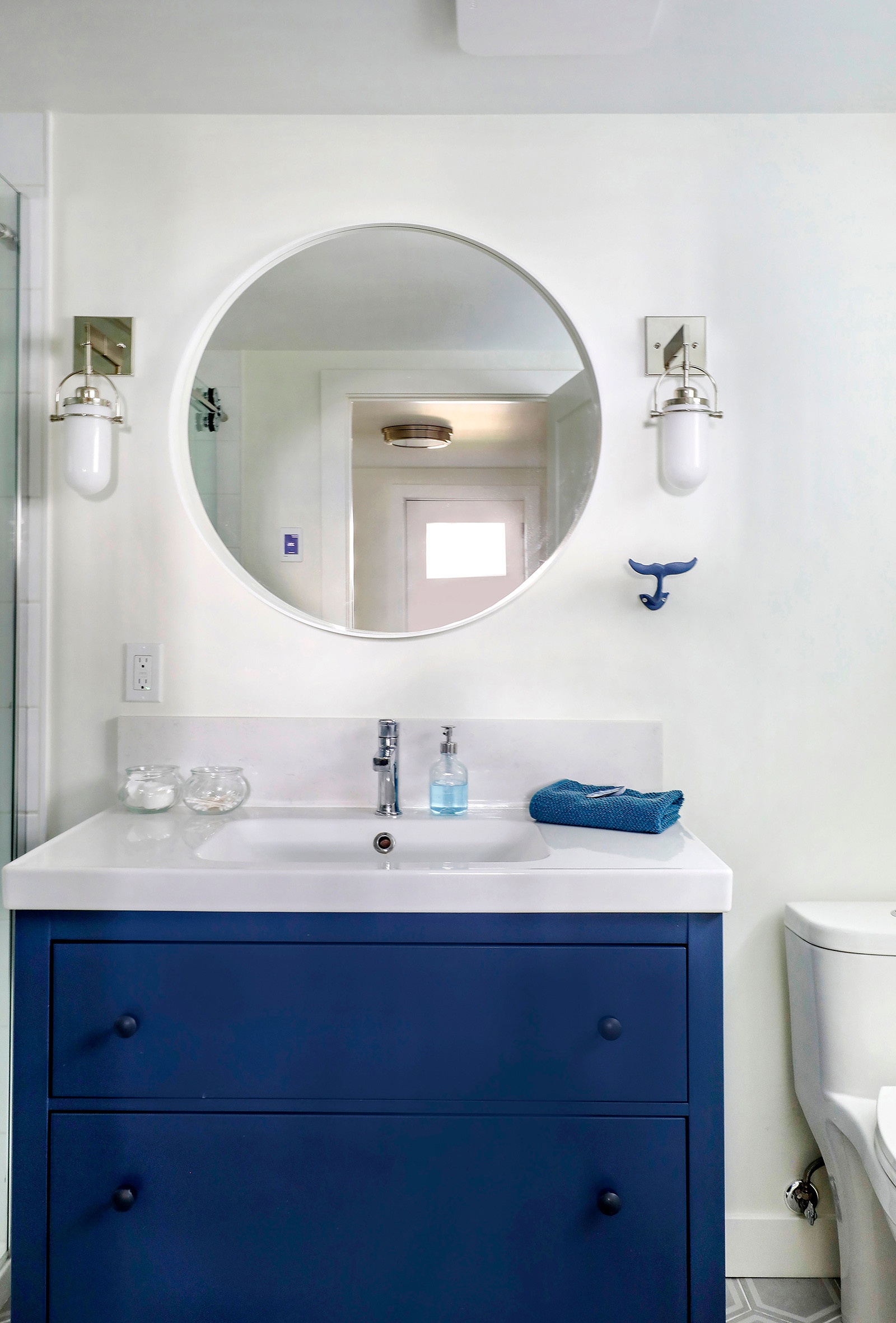  Looking to refresh your bathroom on a budget?  I have these IKEA Hemnes vanities in all three of my bathrooms. The roomy drawers are so much more convenient than digging around inside a cupboard. Nautical inspired lights from Home Depot are hung on either side of the mirror at face height which is the most flattering. And the whale hook for the hand towel adds a touch of whimsy  

 

#LTKhome #LTKstyletip