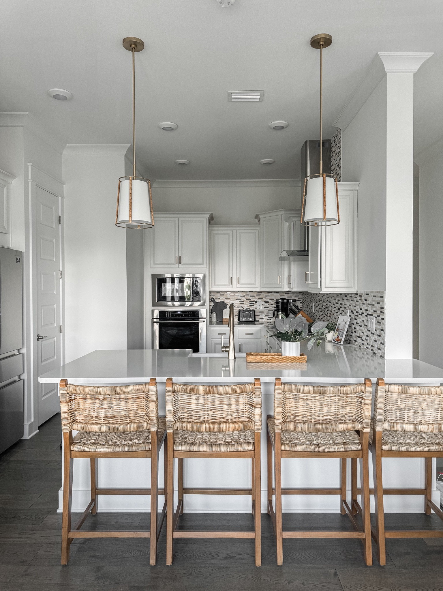 Beach home kitchen views! I accidentally found these pendants online one day. They couldn’t be more perfect for the space with the brass & rattan hardware!! 

I also love these rattan stools. They’re constantly going on sale or have coupons available! Also comes in bar height. 

#LTKHome #LTKStyleTip #LTKSaleAlert