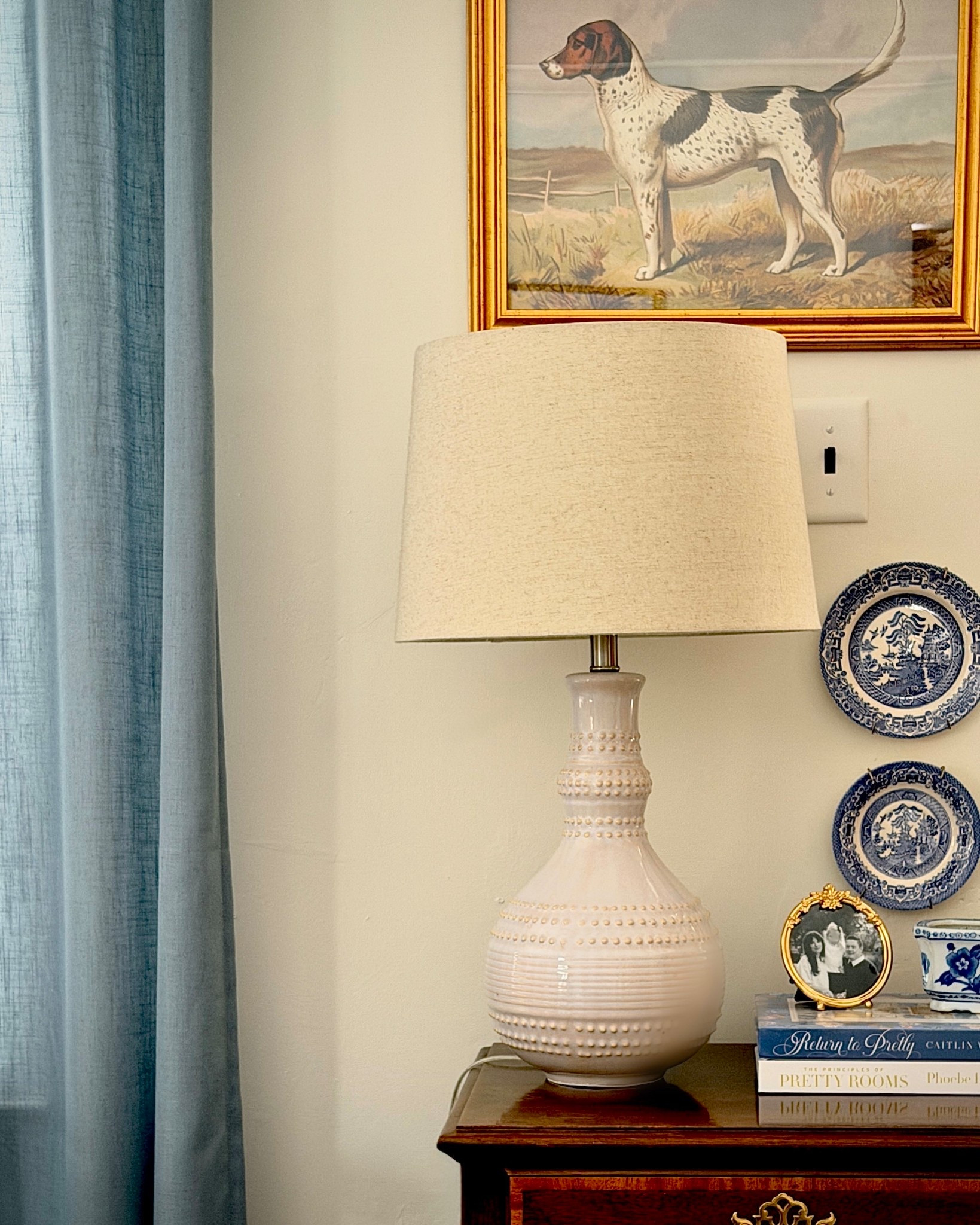 A refined traditional vignette layered with blue-and-white china, warm brass accents, and a sculptural ceramic lamp. Framed sporting art, stacked design books, and heirloom-inspired details create that collected, old-world charm that feels straight out of an English countryside estate. Classic, cozy, and effortlessly timeless.

Save for classic home decor and elevated living inspiration.

#liketkit 
#ClassicHomeDecor #TimelessInteriors 
#TraditionalHome #MaeveAndJames

Follow my LTK @Maeve&James on the @shop.LTK app to view this post and shop this look!

#LTKHome