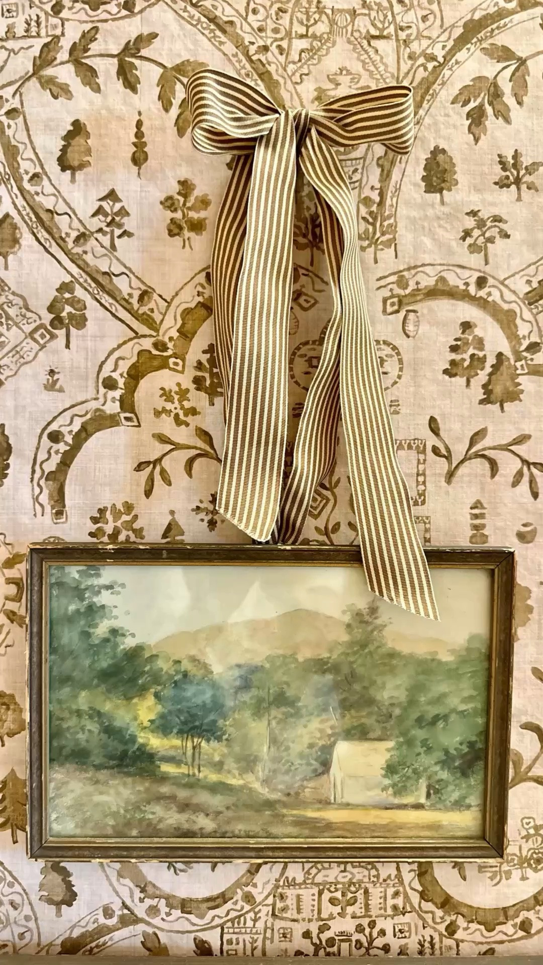I’ve had lots of questions about the ribbon on the vintage artwork in this bathroom makeover. 

I just stapled the ribbon (right in the center of the length of ribbon) to the back of the piece of art. 

Then I tied it in a bow and attached it to the wall with a sticky dot. 

I love the pattern on pattern situation of the striped ribbon  with this beautiful new wallpaper.

#LTKHome #LTKdayinmylife #LTKOver40