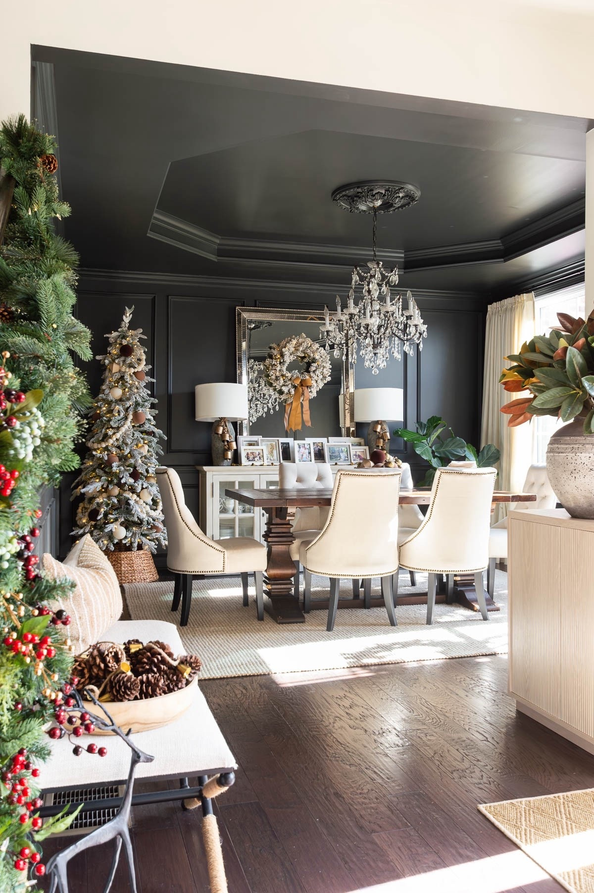 I think the Iron Ore walls and ceiling in my dining room provide the perfect backdrop for holiday decor. I’ve added a slim flocked Christmas tree, decorated simply with neutral colored ornaments and large cream ball garland. A rattan tree collar completes the look. This year I added my gallery of our Christmas photo cards to the sideboard and added an arrangement of bells and balls in a wooden bowl to the dining table. home decor dining room decor Christmas decor crystal chandelier wool jute rug landscape art dining chairs

#LTKStyleTip 

#LTKHome #LTKHoliday