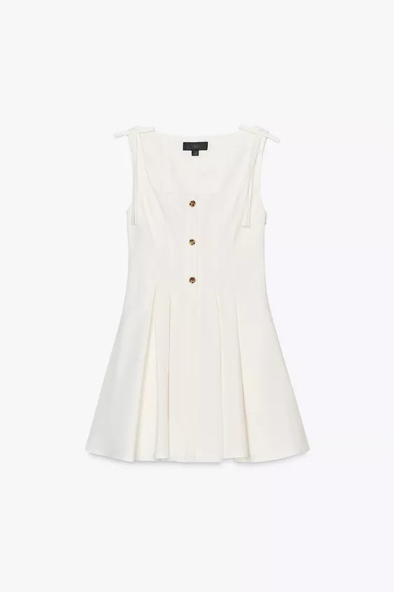 Short dress made of 24% linen. Square neckline and straps with bow appliqué. Lining. Featuring p... | Zara UK