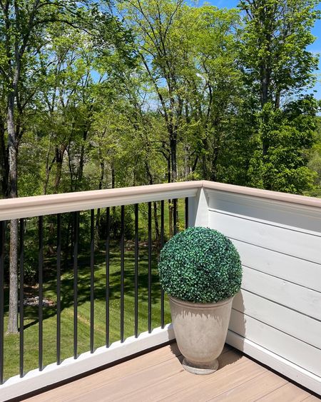 We love these faux concrete planters. Only $20! Just drop a brick inside to weigh them down. The topiary has held up so well, too. We love them so much we have four. 