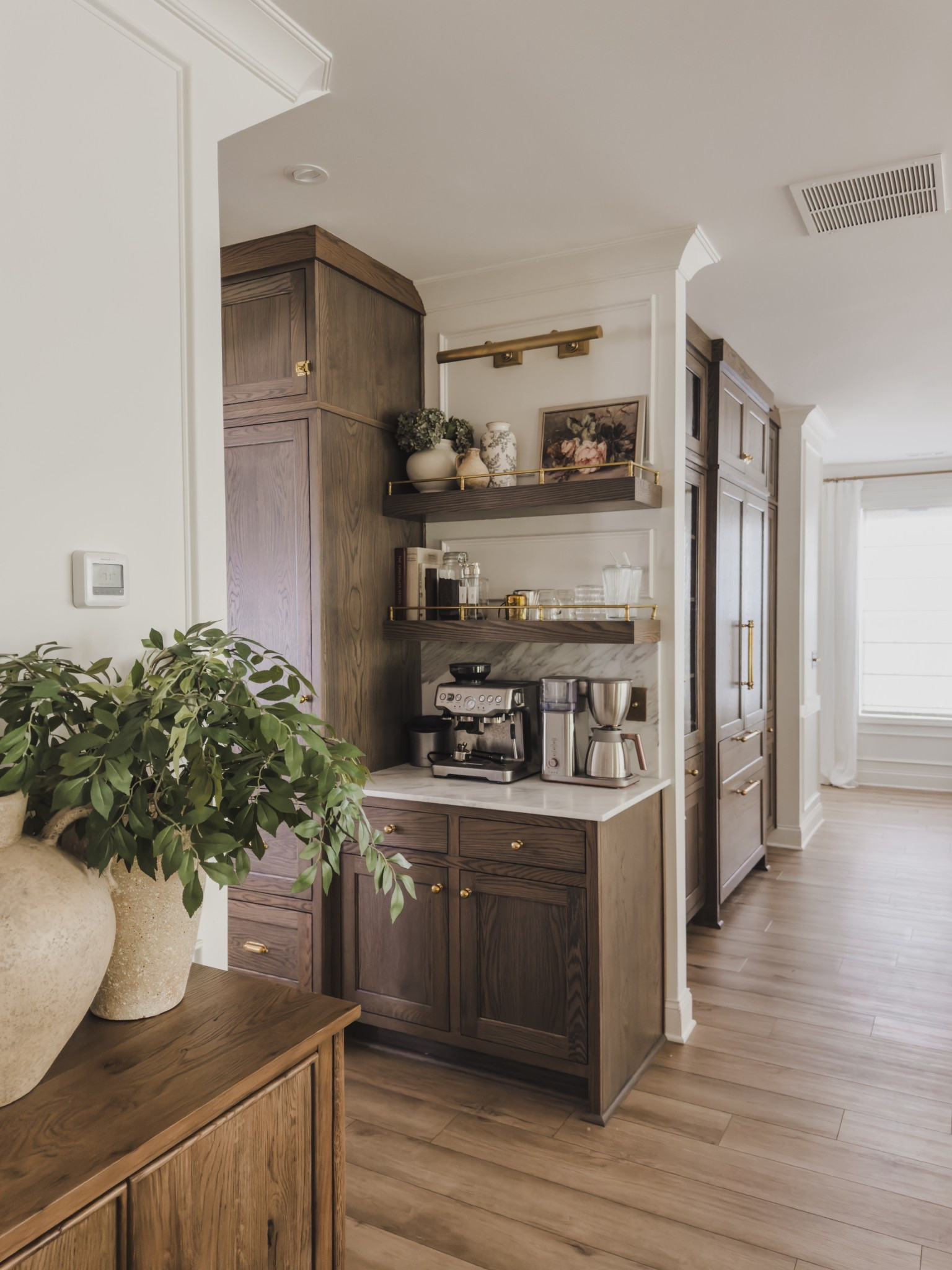 A question I get frequently is about my coffee bar shelves. The open concept with a brass gallery rail is giving all the vibes. The shelves were part of my custom build but have sourced some great similar options of my shelves and hardware!

Home finds, coffee bar views, unlacquered brass, neutral wood tones, neutral home inspo, hardware details, open concept shelving, picture light, Rejuvenation, aesthetic home finds, Etsy, Wayfair, Visual Comfort, shop the look!

#LTKSeasonal #LTKStyleTip #LTKHome