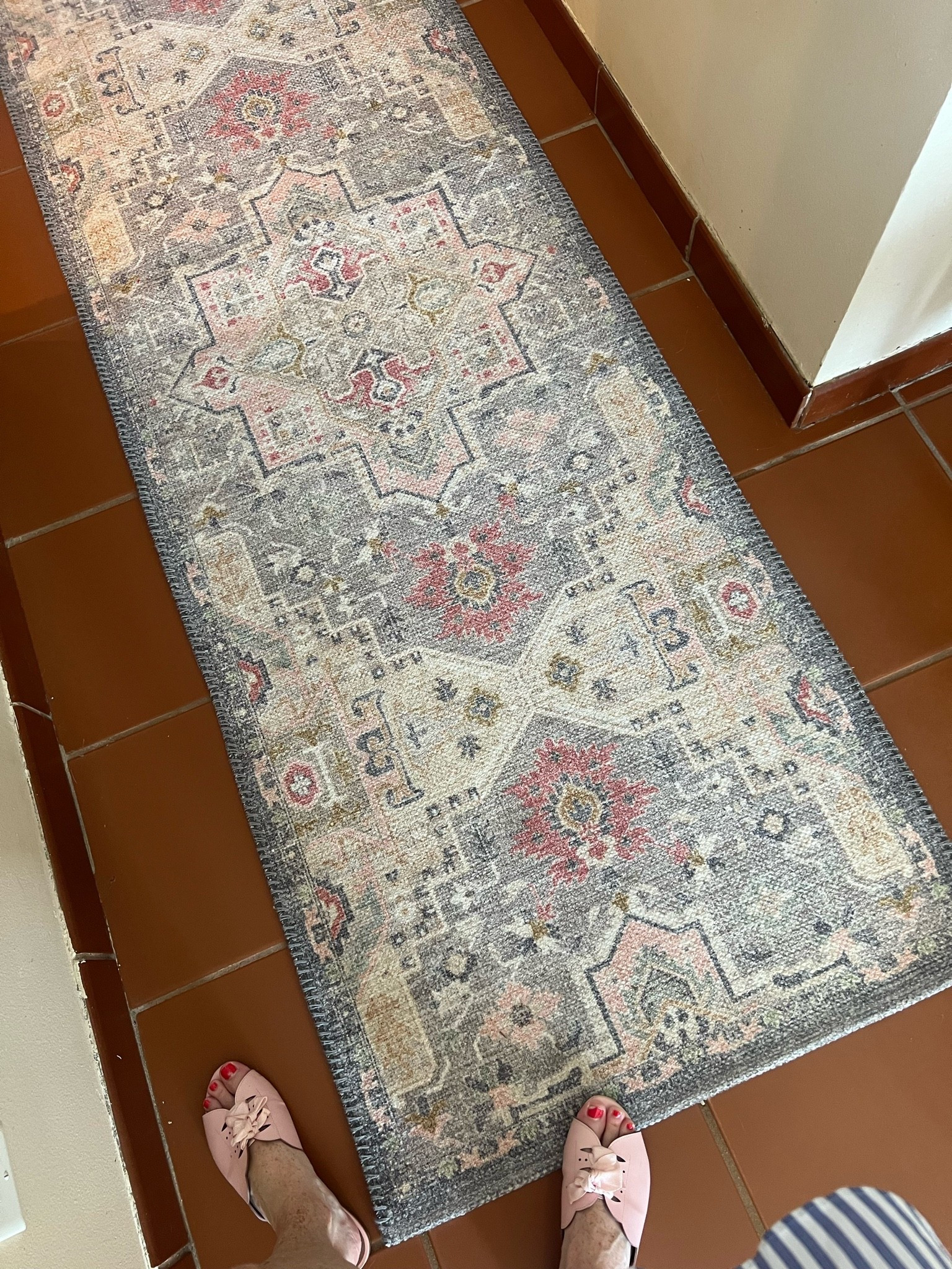 The hallway between the garage and kitchen deserves a little love too. This is one of the first new pieces we’ve added to our new home, and this washable vintage-style runner adds warmth, color, and character to one of the hardest-working spaces in the house. I also love the non-slip rubber backing—it stays put and helps absorb water on rainy days, making it as practical as it is beautiful. 

These are the original terracotta floors. We are going to replace them, thinking of going with a light travertine or travertine looking tile. 

Hashtags:
#LTKHome #HallwayDecor #RunnerRug #FrenchCountryStyle #VintageStyle #EntrywayDecor #WashableRug #HomeDecorFinds #ClassicHome #NewHome